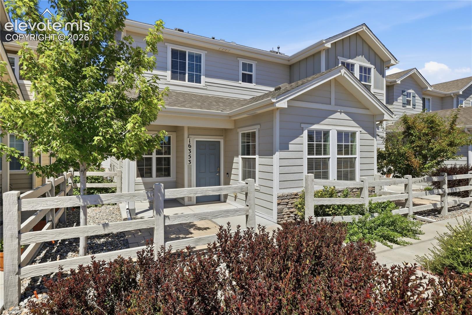 Light gray siding exterior with stone accenting