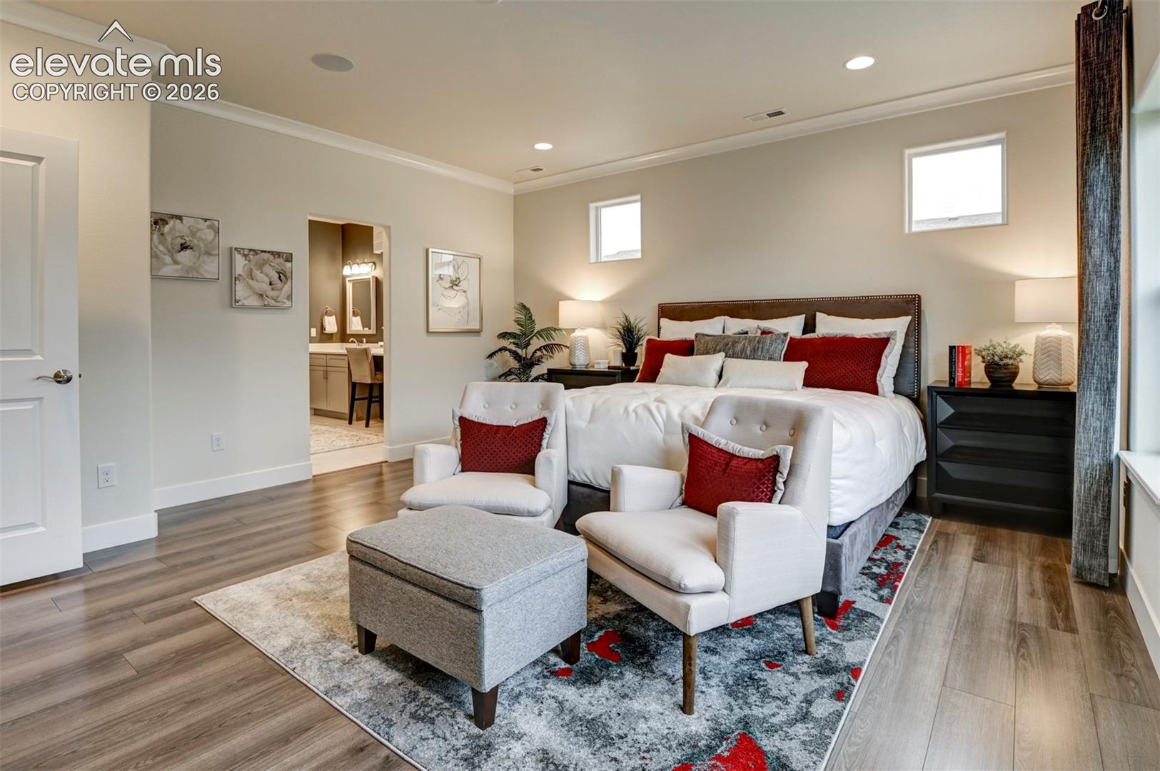 Wood-finish flooring, recessed lighting, crown molding, and two transom windows