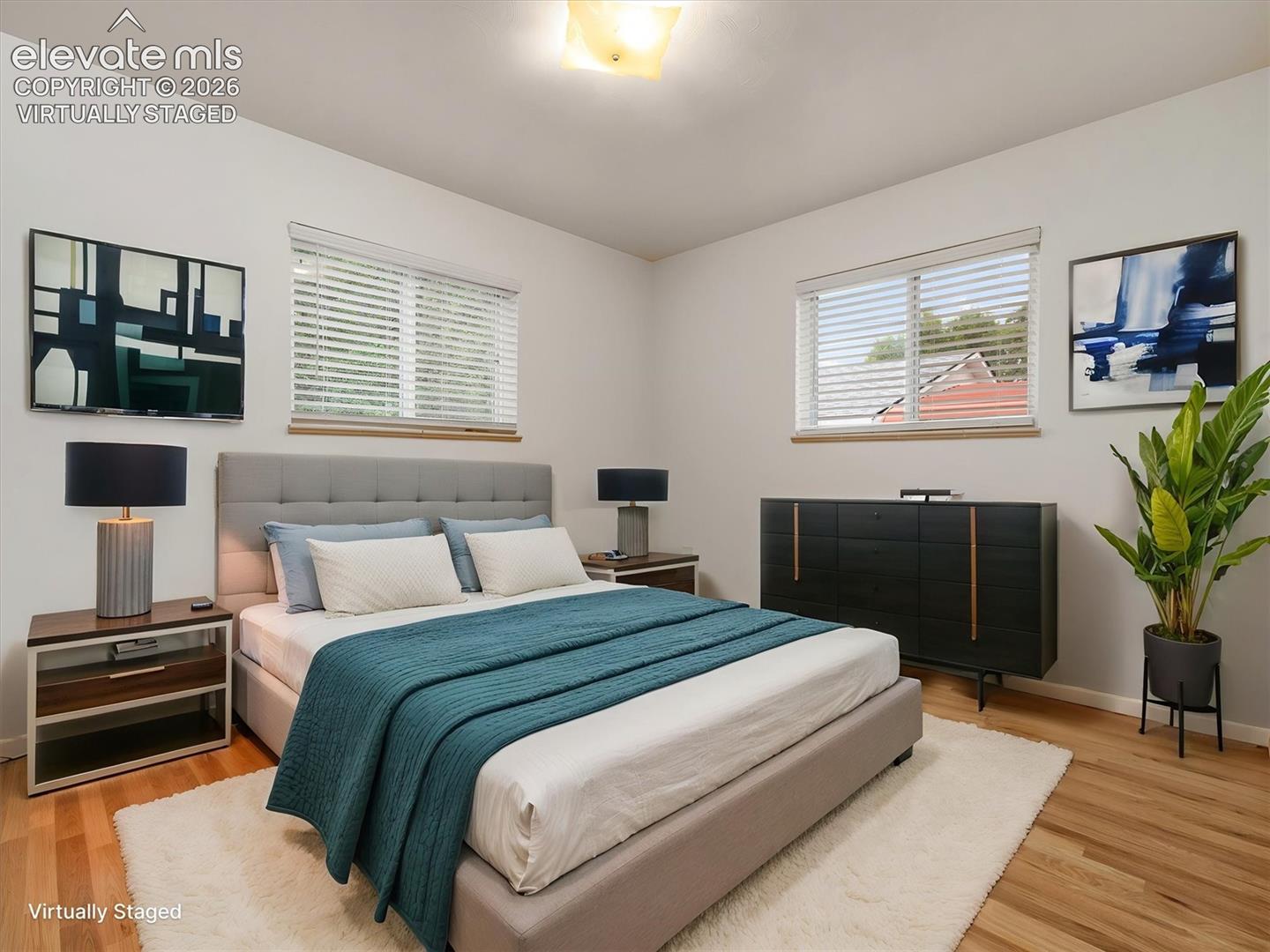Virtually Staged, Hardwood-finish flooring, white walls, and two windows with blinds