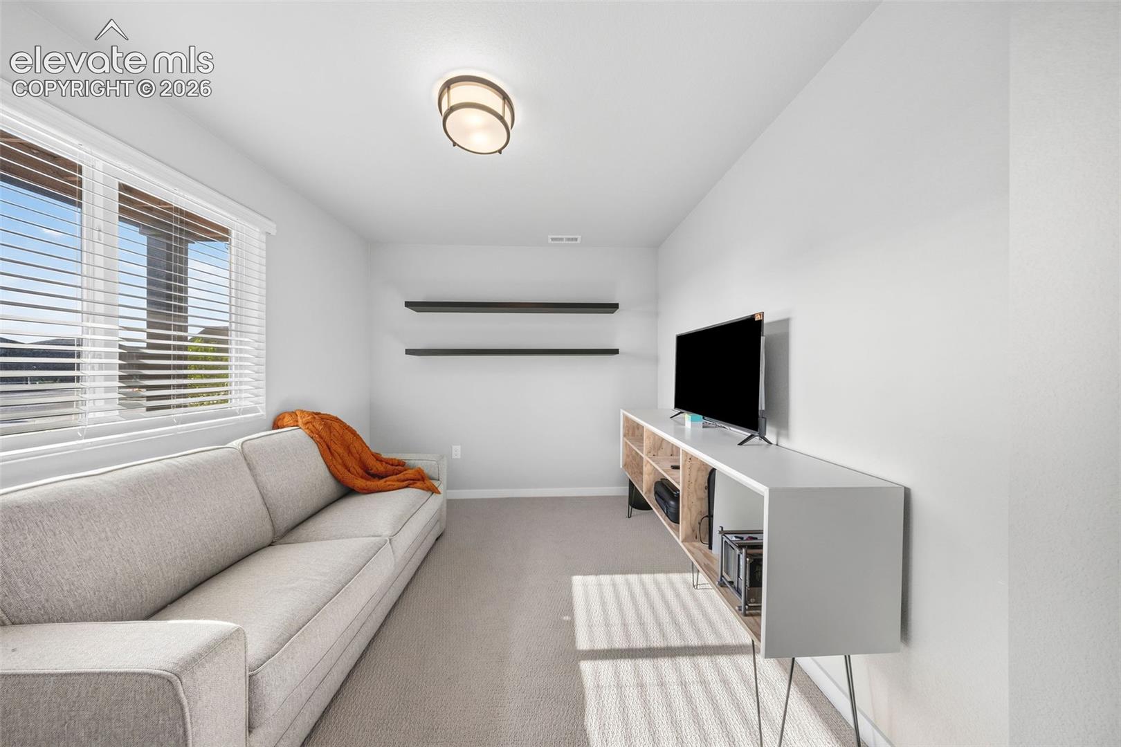 This lower-level bedroom is currently in use as an office. It has an adjacent full bath with a tub/shower combo. 