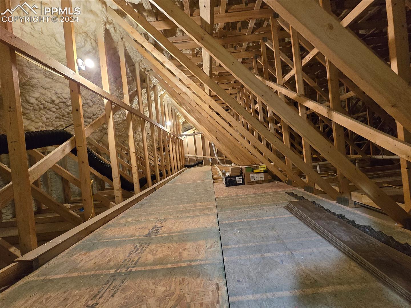 View of attic with plendy of storage space. This attic is accessable from the loft through a small door on the side of the attic