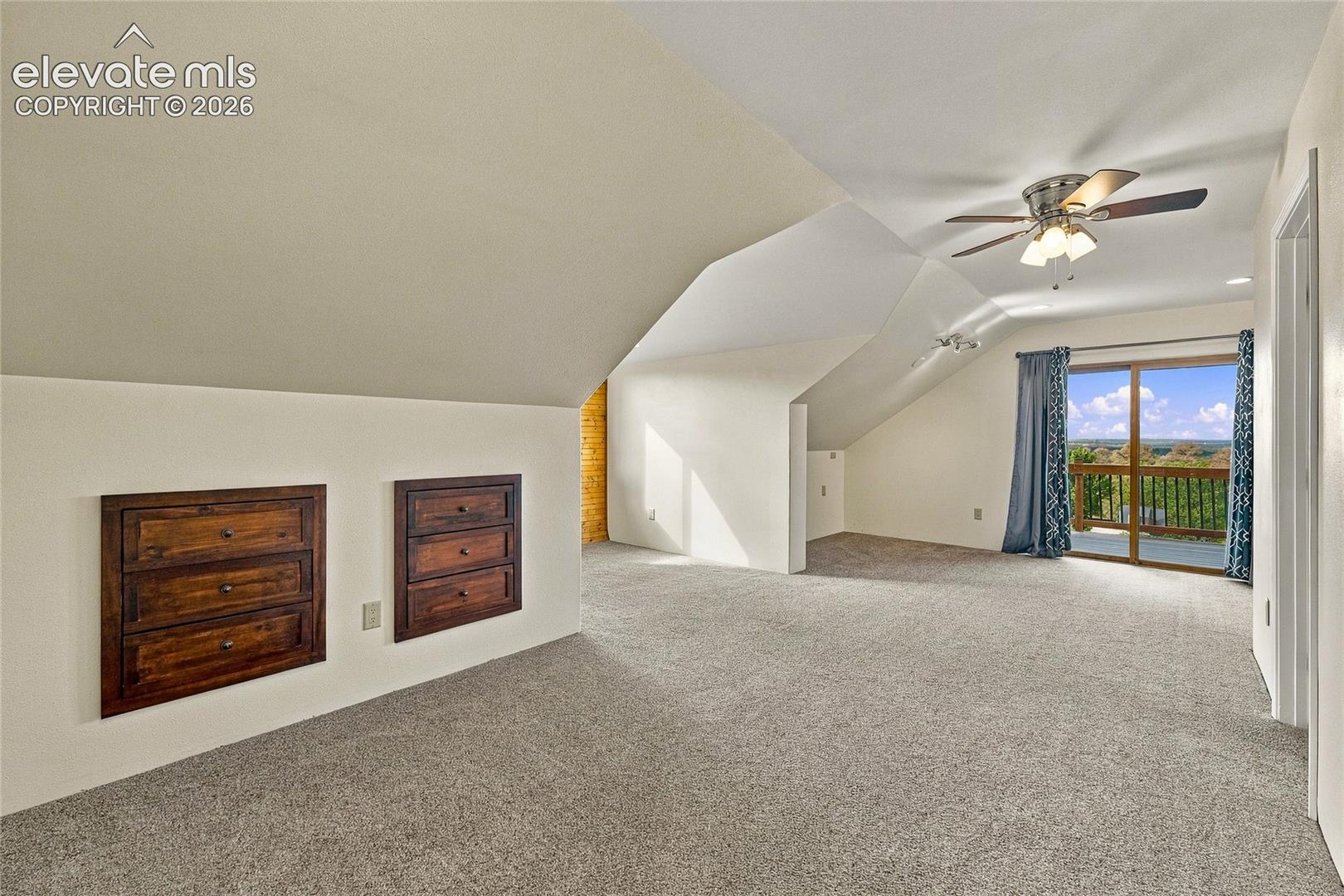 Upper level bedroom with built in storage and access to balcony