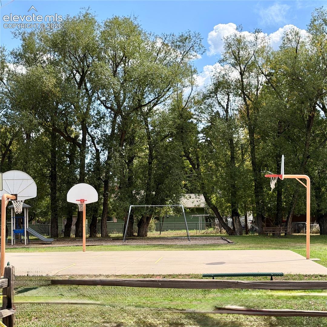 Outdoor concrete sports court with multiple basketball hoops in the town