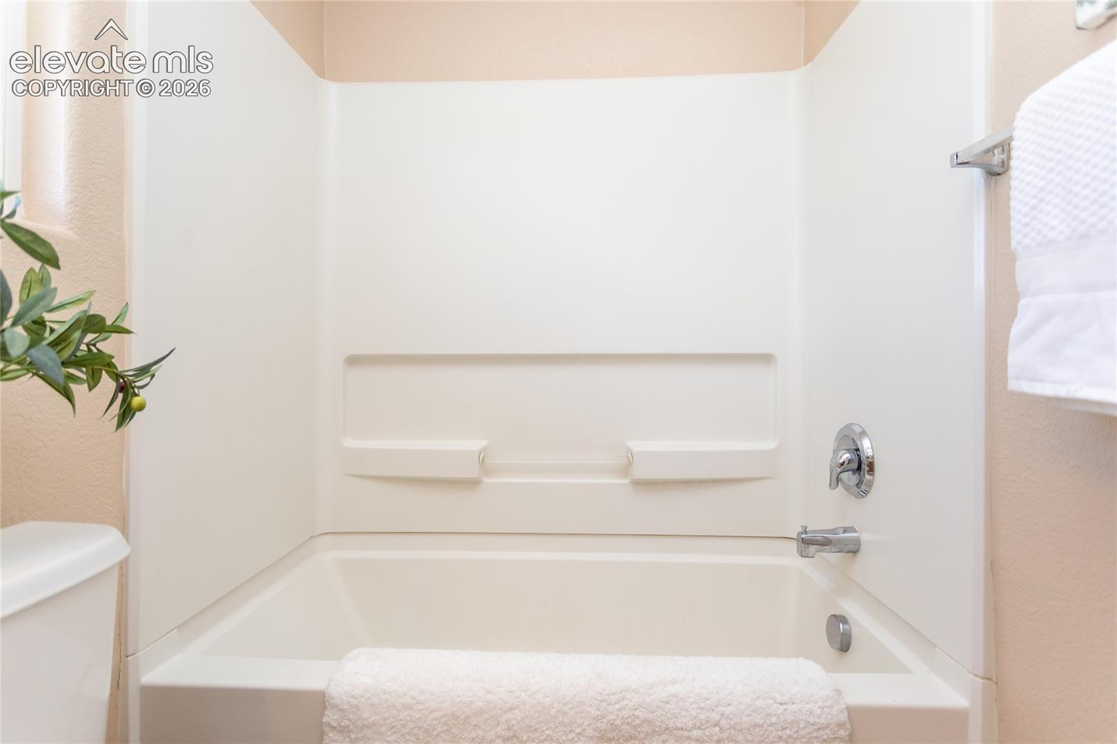 The upper-level full bathroom provides a tub and shower setup convenient to the secondary bedrooms