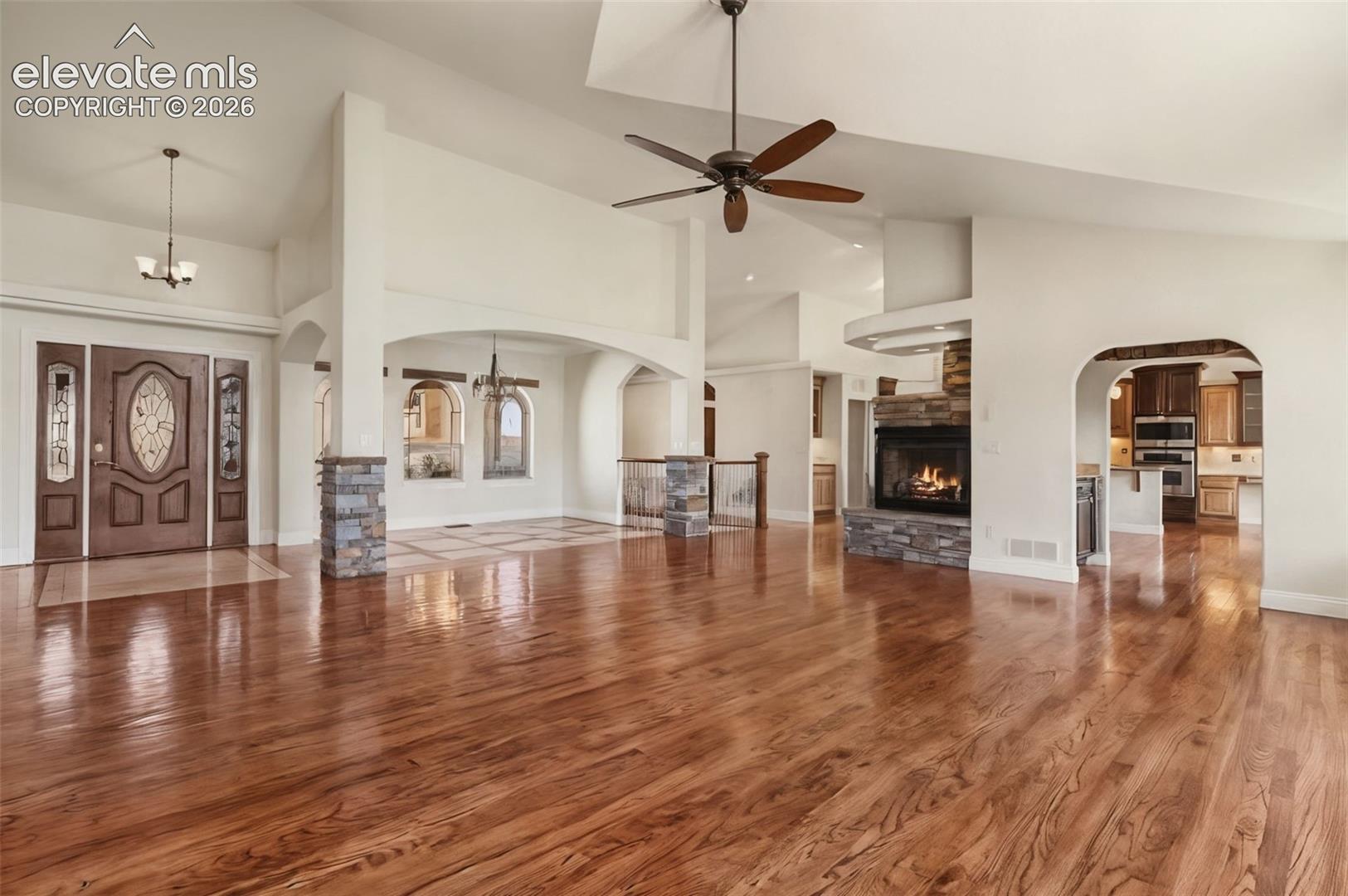 Stunning Great Room, Vaulted Ceilings, Solid Wood Floors, Windows of Natural Light, Gas Fireplaces, Built-In Bookshelves