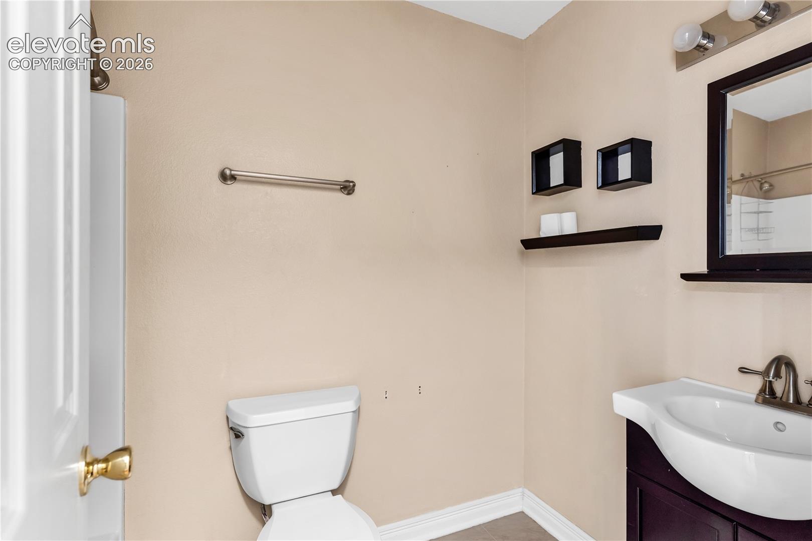 White toilet with wall-mounted towel bar