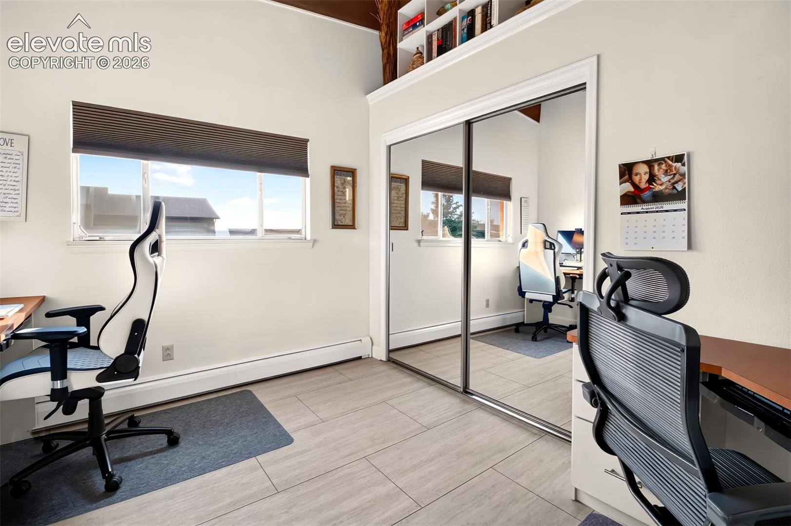 A secondary bedroom on the main level  has shelves and clothes rod in the closet