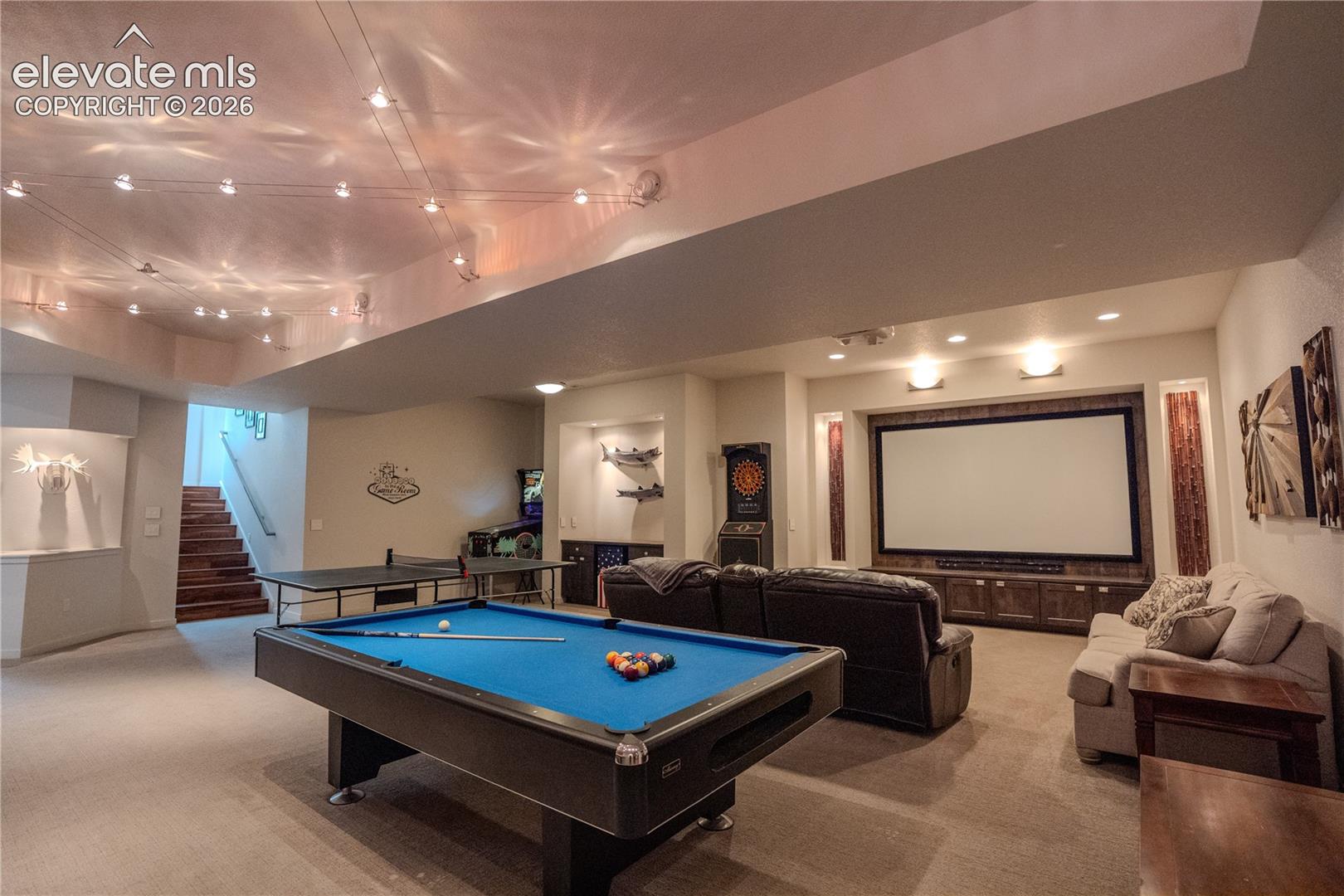 Theater room, pool table, shuffle board, exercise room, 2 bedrooms, bath and laundry are all down here. Game pieces can stay or go!