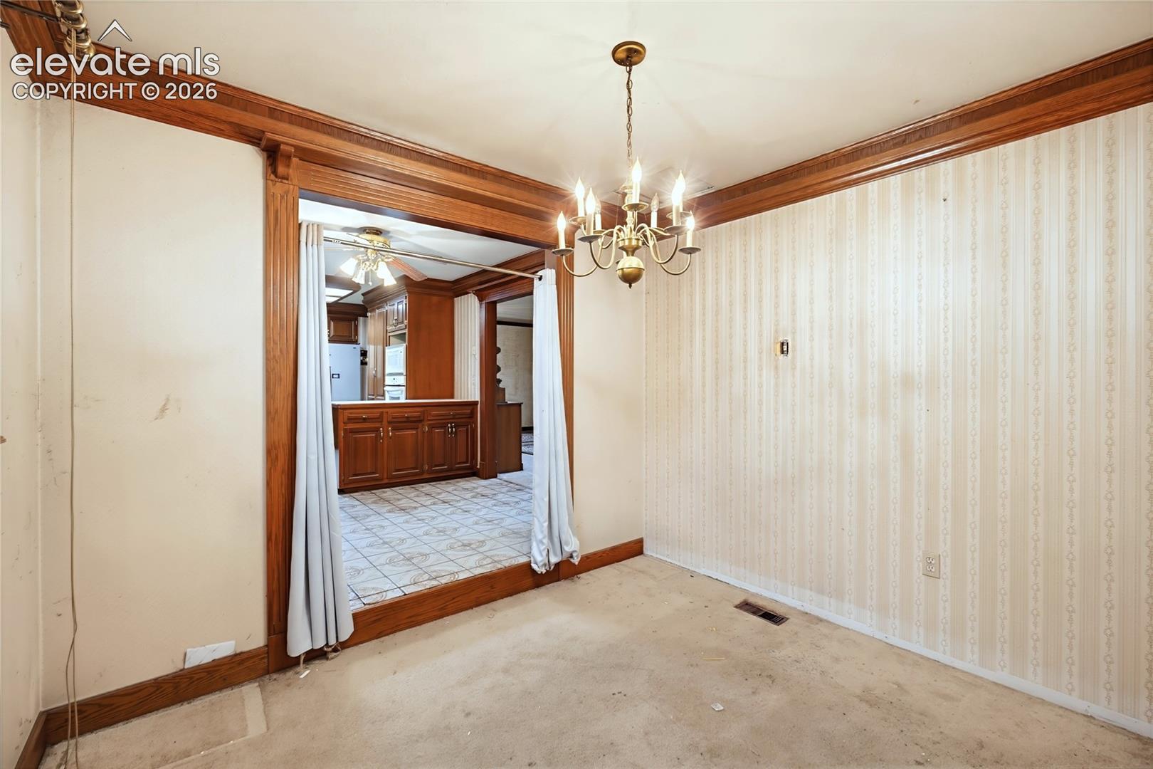 Brass chandelier and extensive wood trim accents