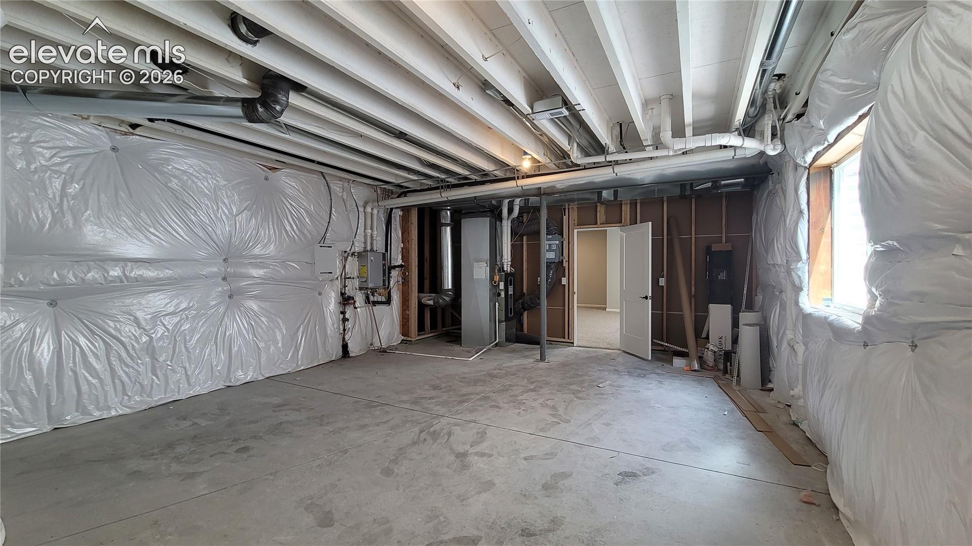 Storage/Utility room with a tankless water heater, 96% energy efficient furnace with a variable speed motor, sealed ducts, pex water piping, active radon mitigation system in this energy rated home! 