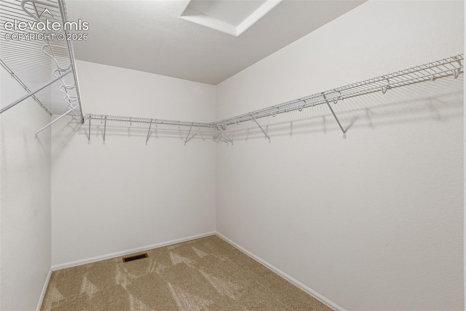 Organize your wardrobe perfectly in the primary suite's oversized walk-in closet, offering exceptional storage