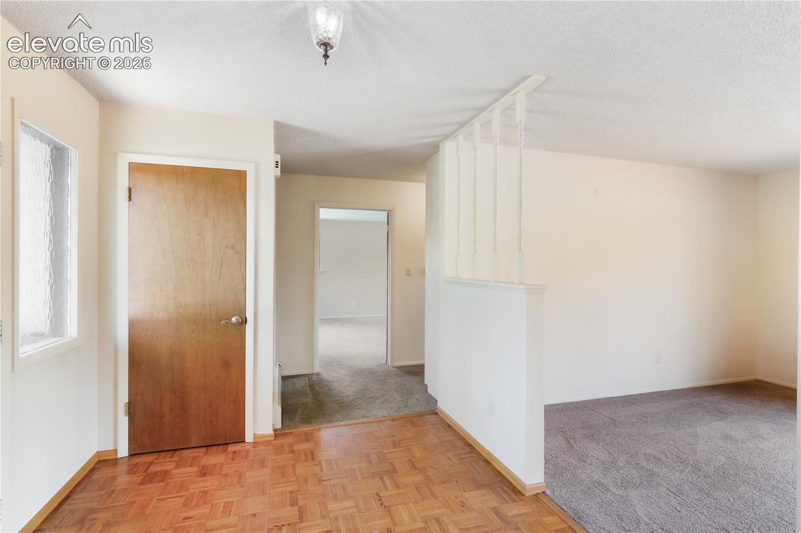 Entryway with coat closet, view into the living room