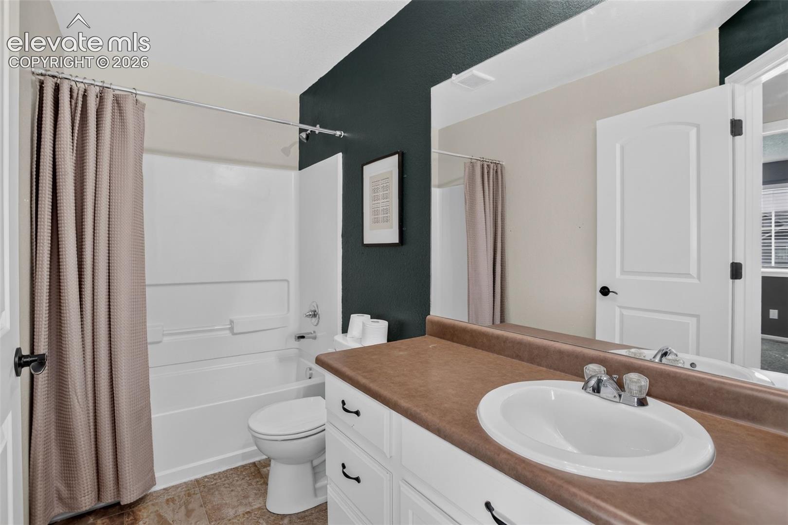 White vanity with a laminate countertop and integrated sink