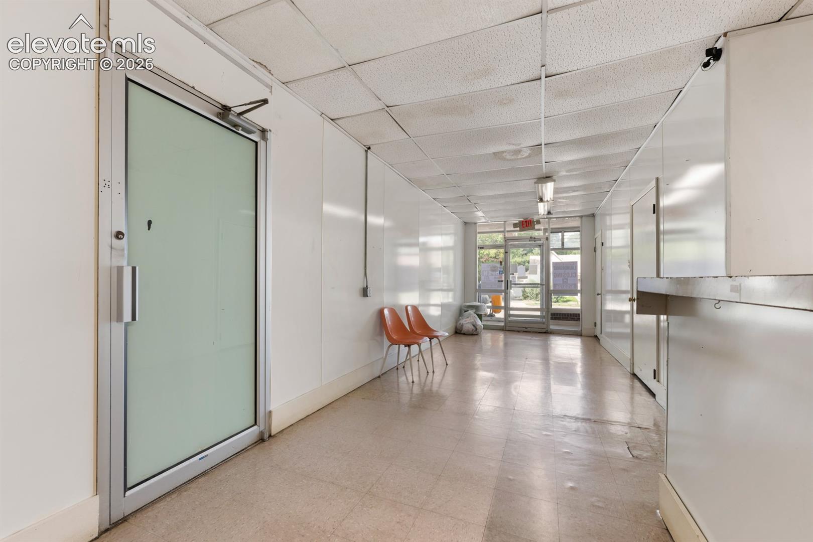 Green door is access to another part of the building that has unused office space