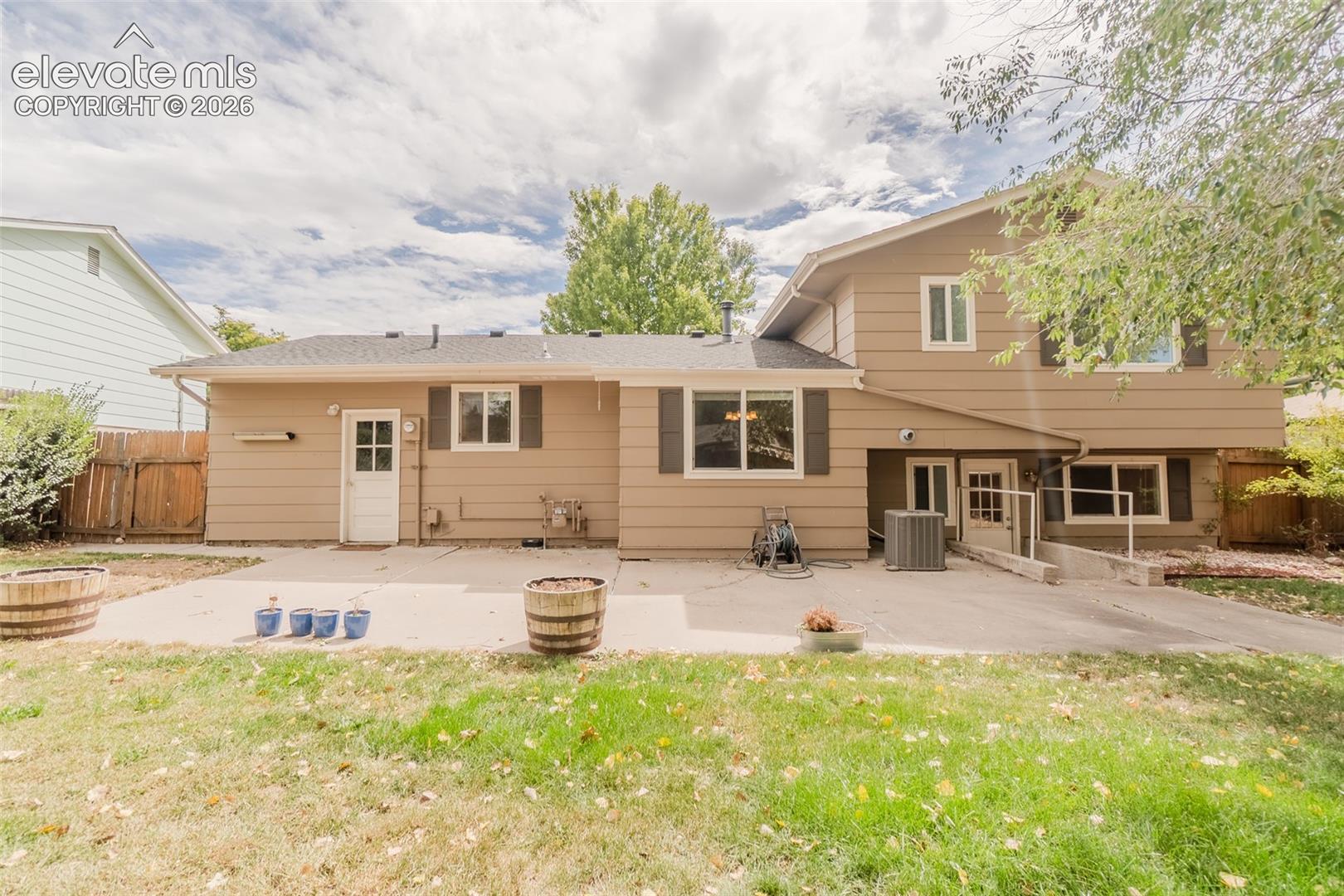 Expansive concrete patio with direct outdoor access and an accessible ramp