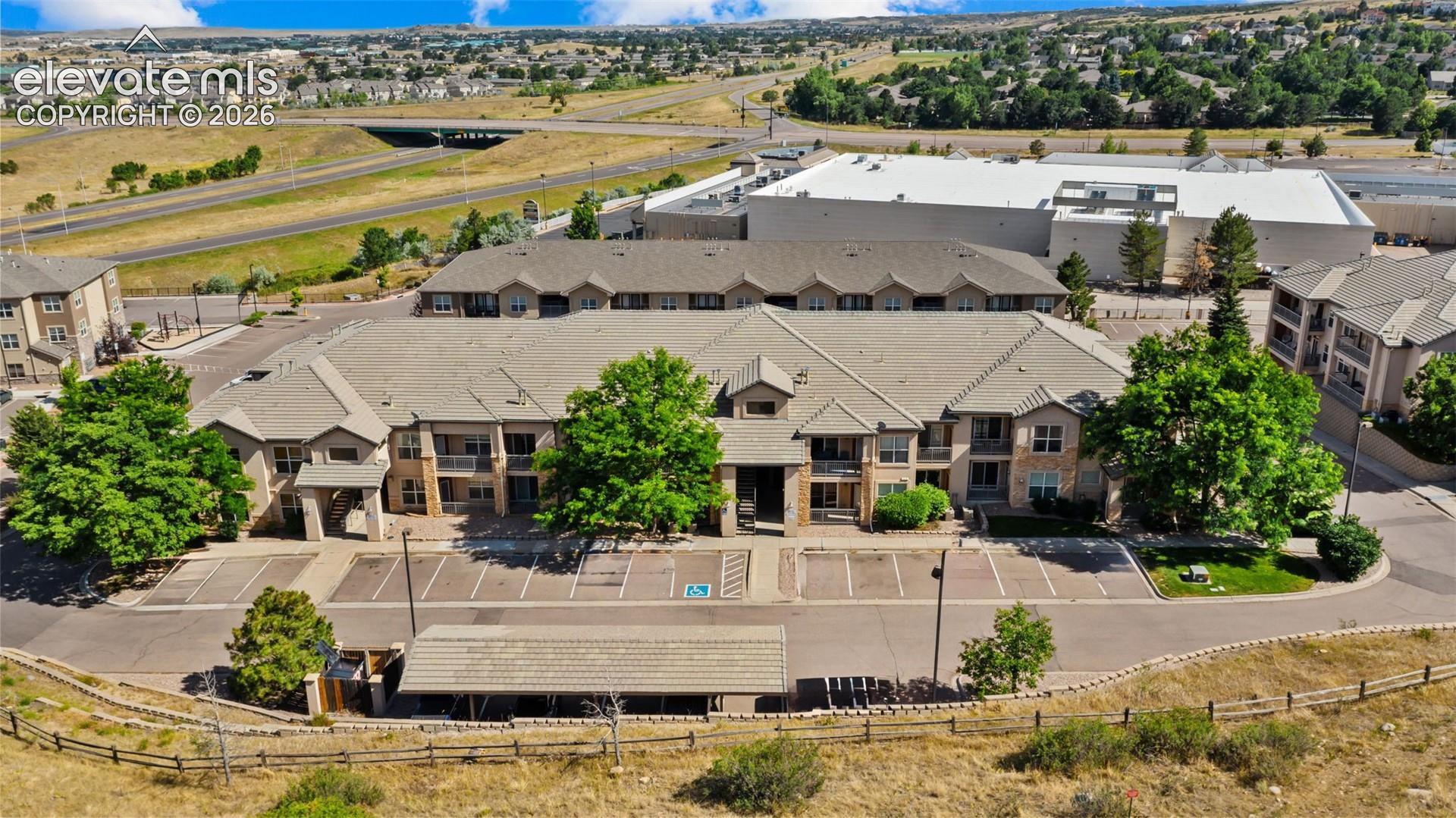 Multi-story residential building featuring stone and siding exterior accents