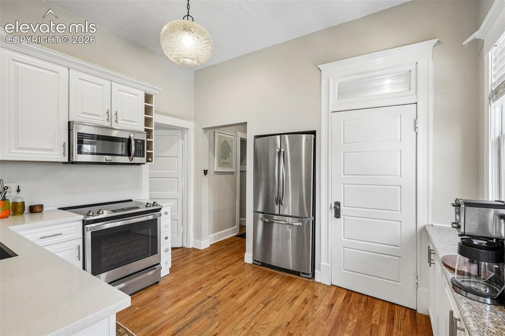 Kitchen with matching stainless steel appliances, wood flooring and plenty of cabinet space