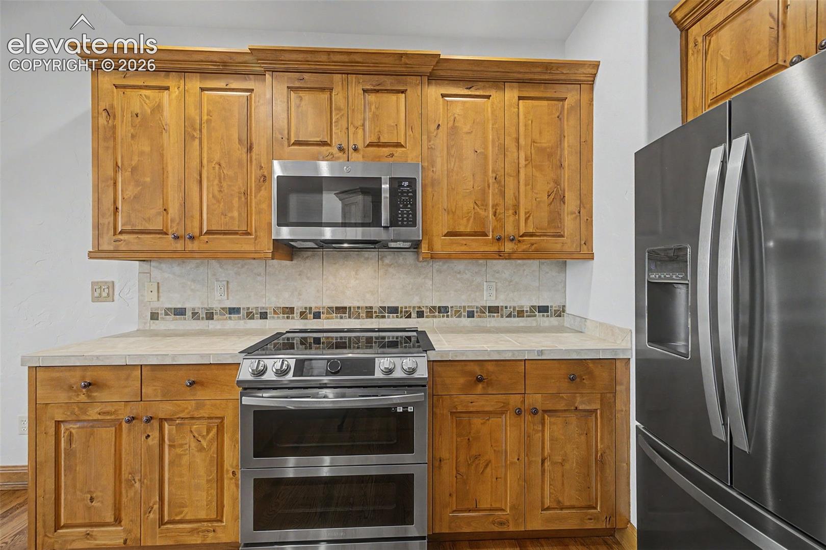 Stainless steel appliances and gorgeous cabinets!