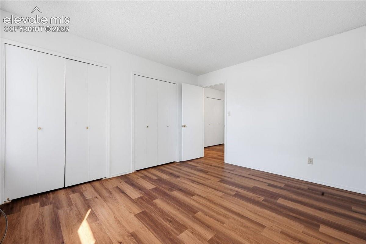 Upper-level bedroom with double closets for extra storage at, Colorado Springs, CO.