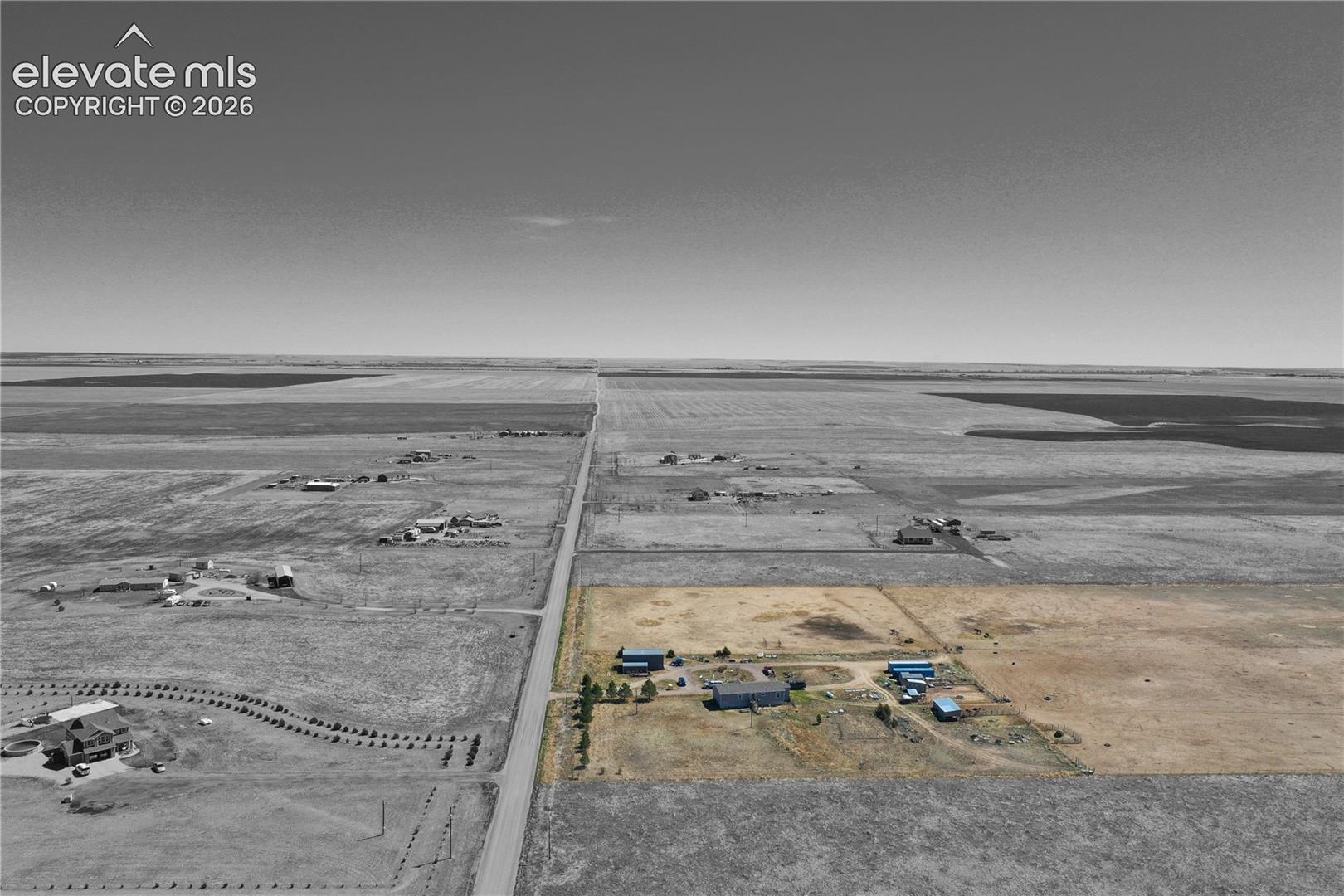Aerial view of sparsely populated area with large plots for crops