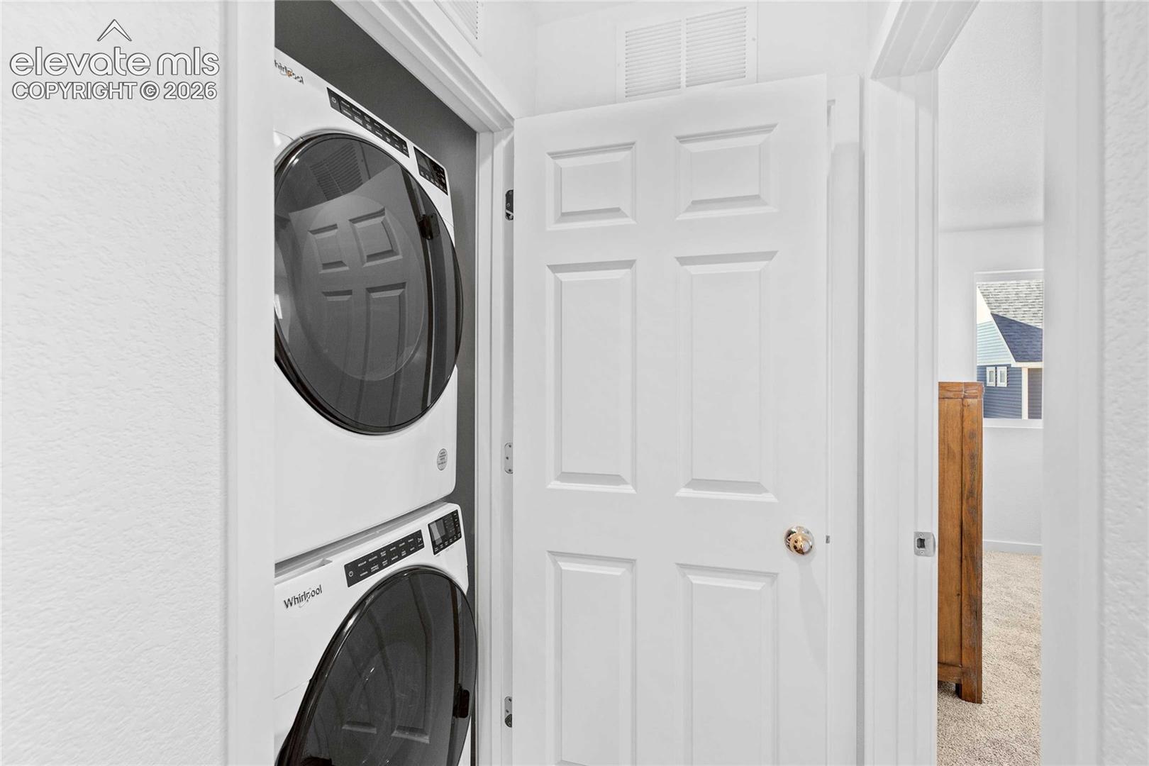Stackable washer and dryer unit within a dedicated closet
*photos of a model home*