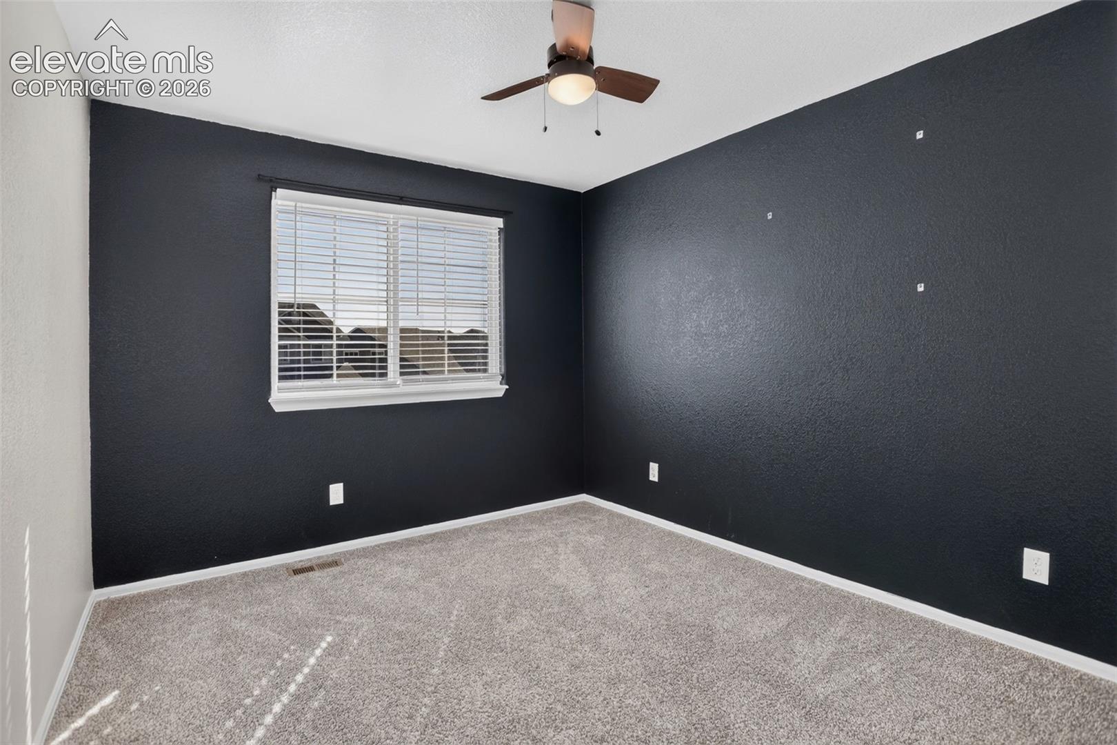 Window with horizontal blinds, overhead ceiling fan with light, and carpeted flooring