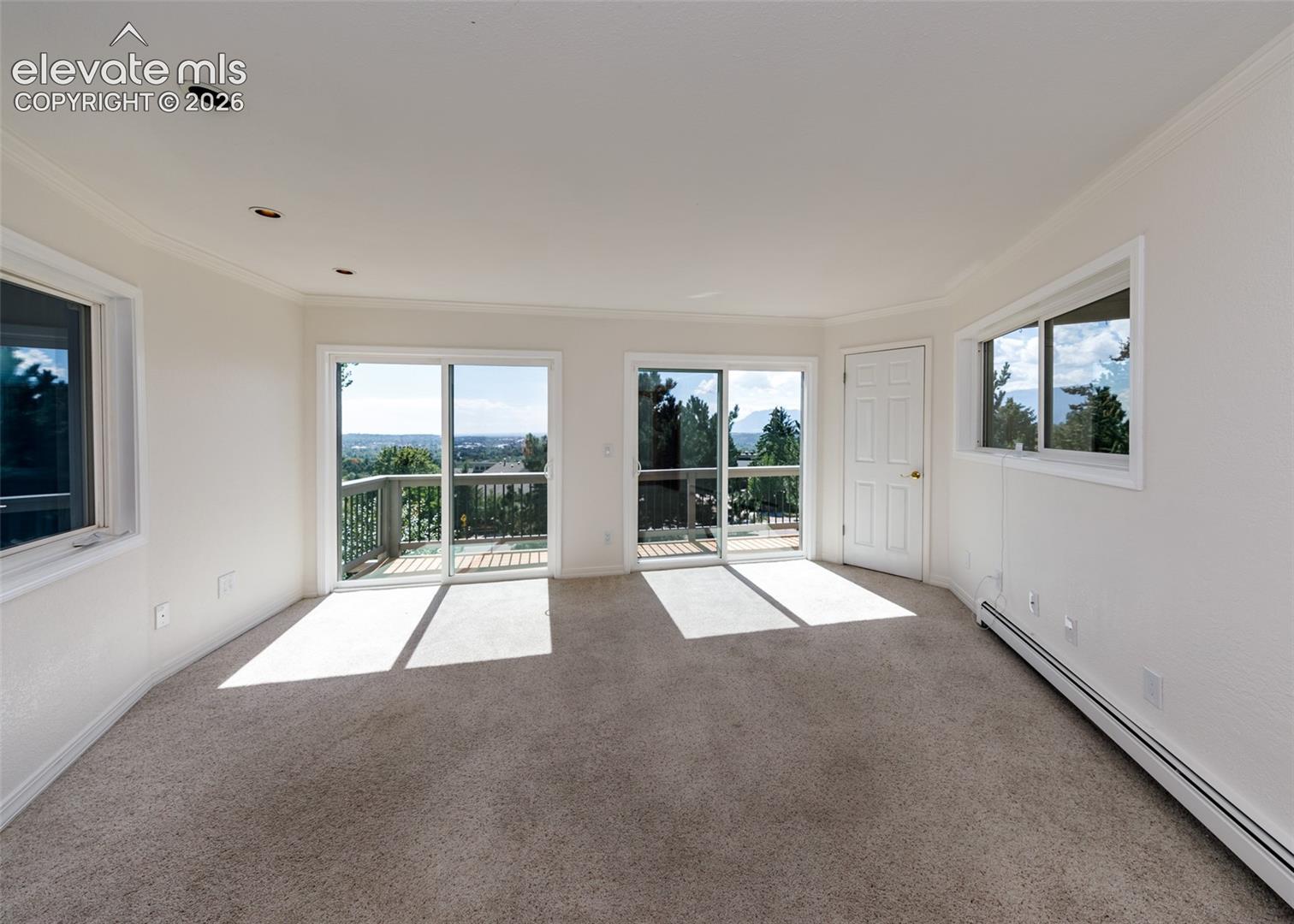 Large office on main level with 2 sliding glass doors to upper deck