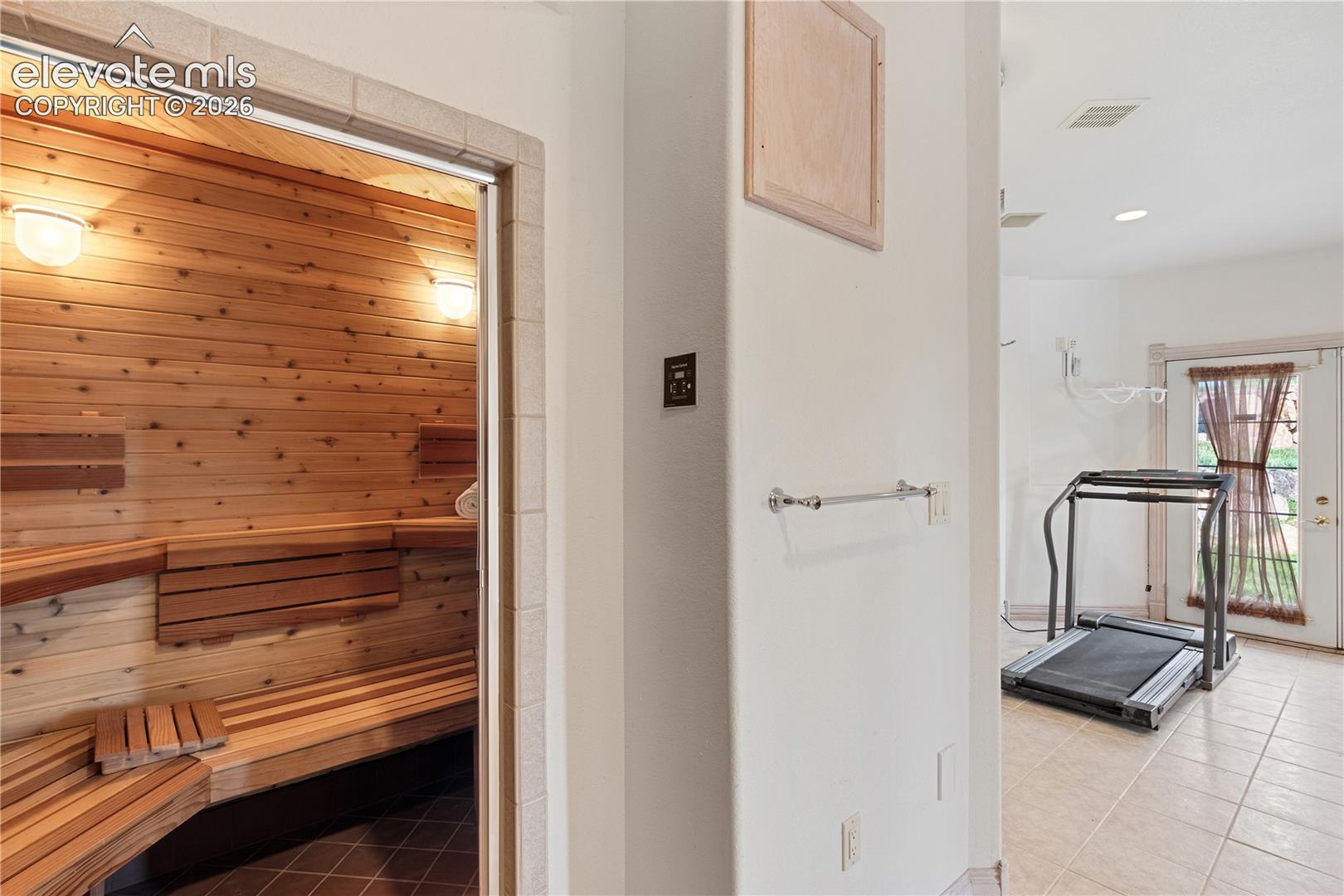 Workout room in basement with sauna and shower