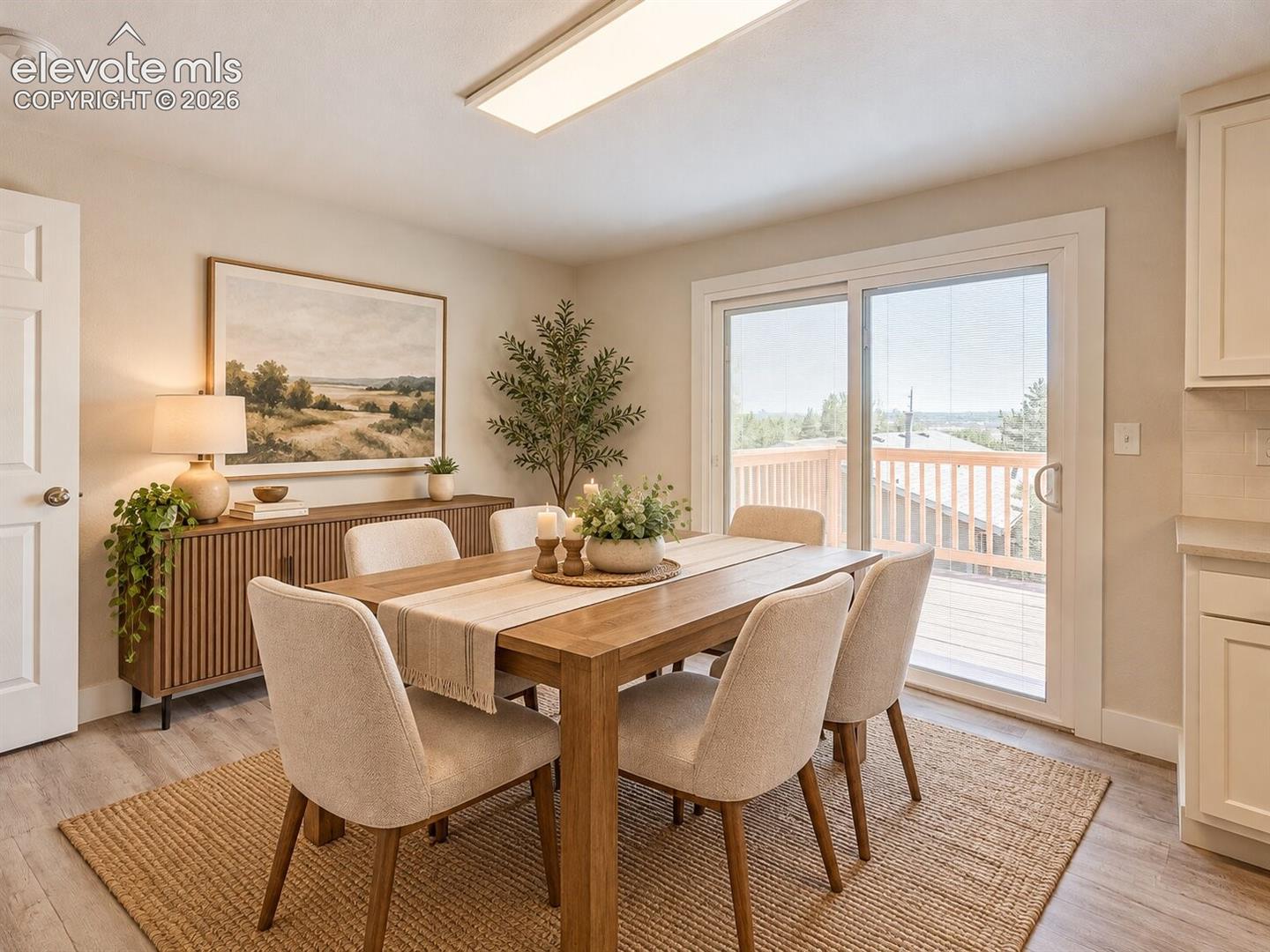 Dining area featuring wood-finish flooring, sliding glass doors, and flush-mount lighting. AI-Enhanced – furniture/decor digitally added