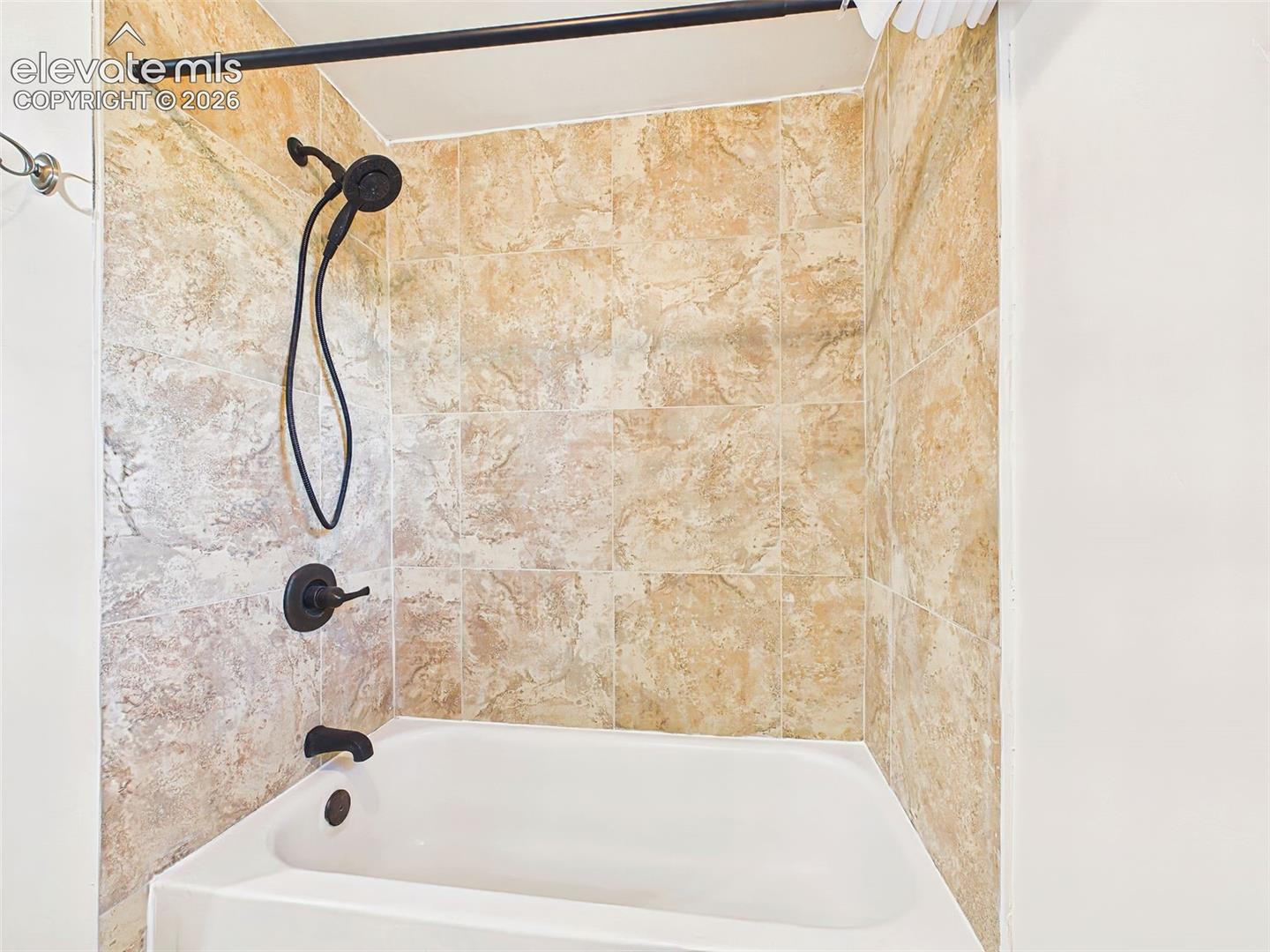 Bathroom – Updated full bathroom features a tiled tub and shower surround with modern fixtures for a clean, timeless look.