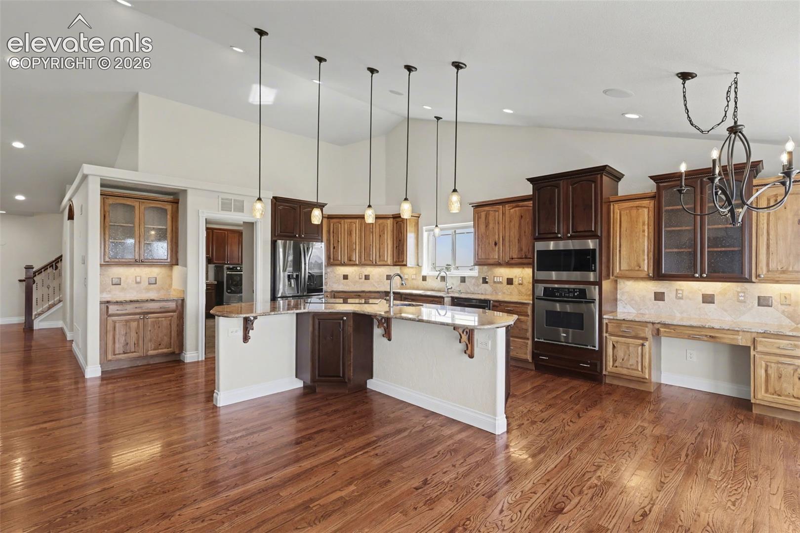 Gourmet Kitchen, Large Island, Granite Countertops, Stainless Steel Appliances, Solid Wood Floors, Pull Out Shelving,  Walk-In Pantry