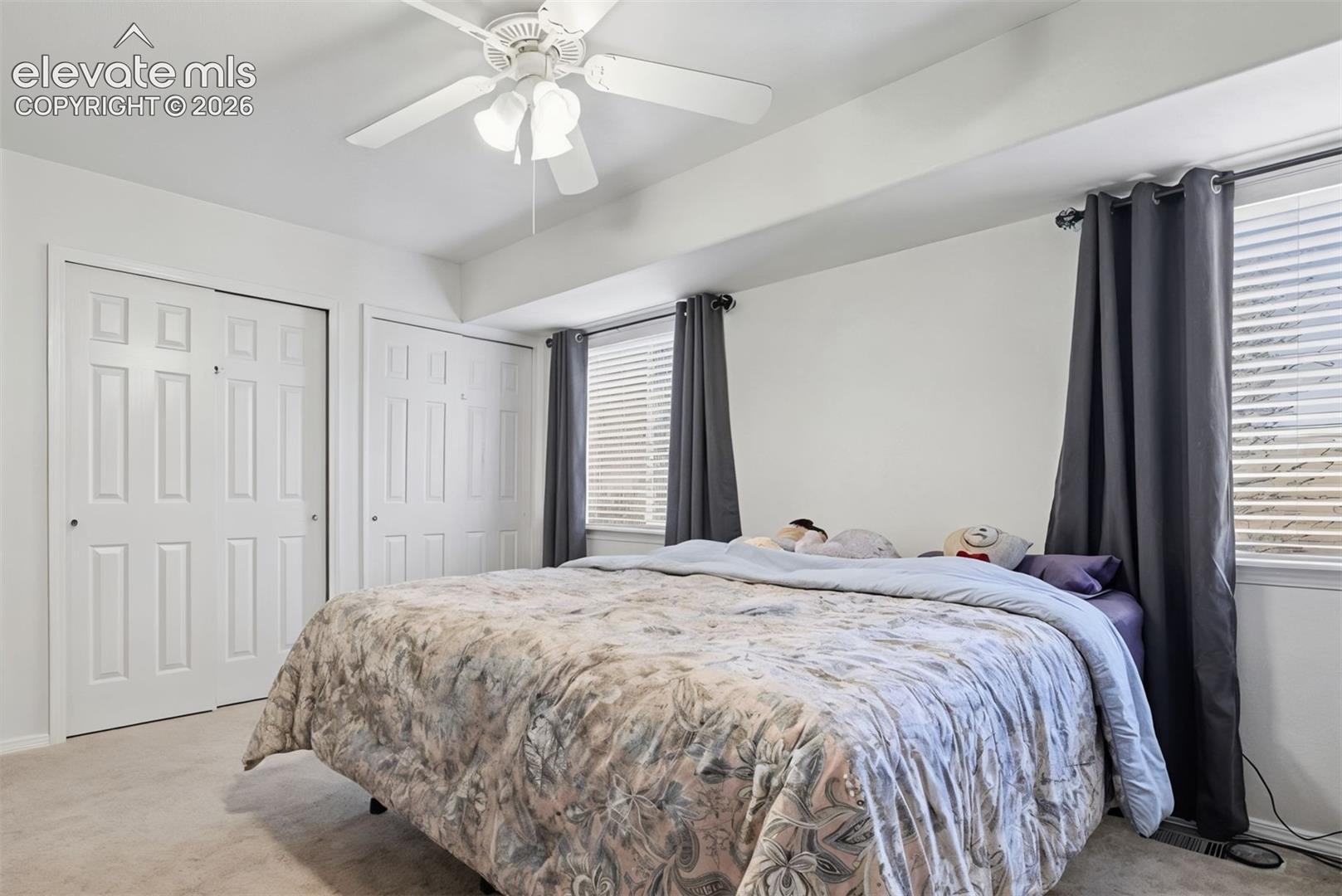 Primary bedroom is on upper level and includes two windows and a ceiling fan