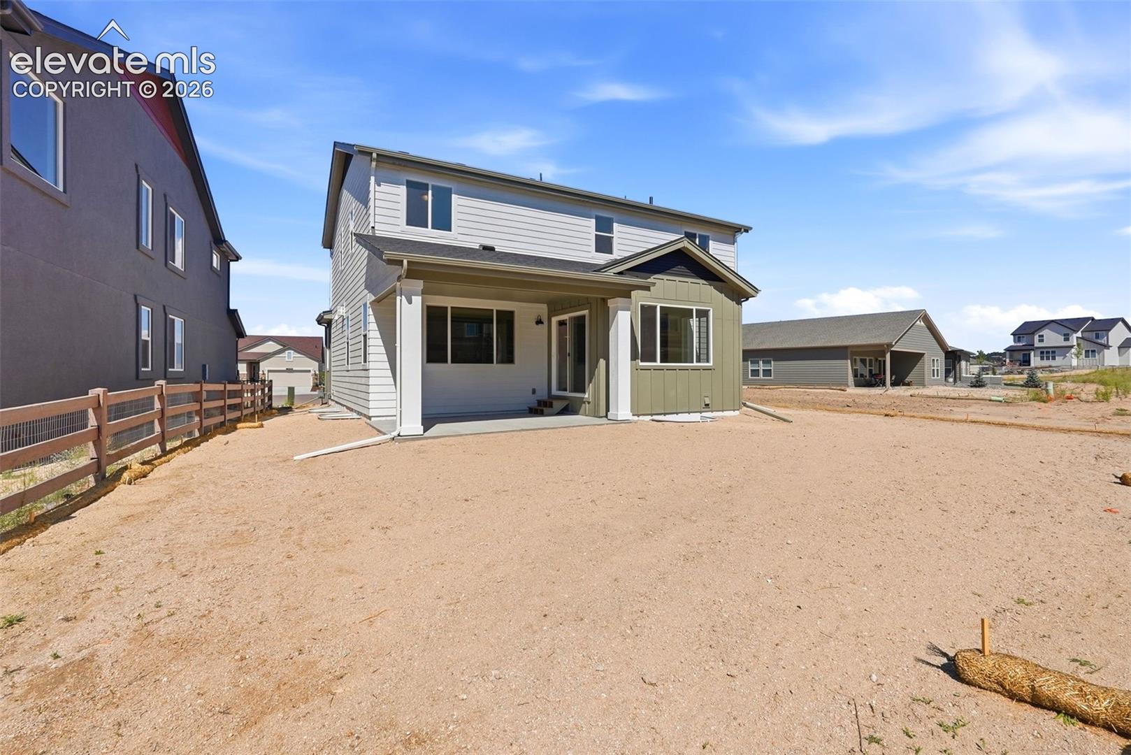 The Covered Rear Patio walks out to a spacious backyard!
