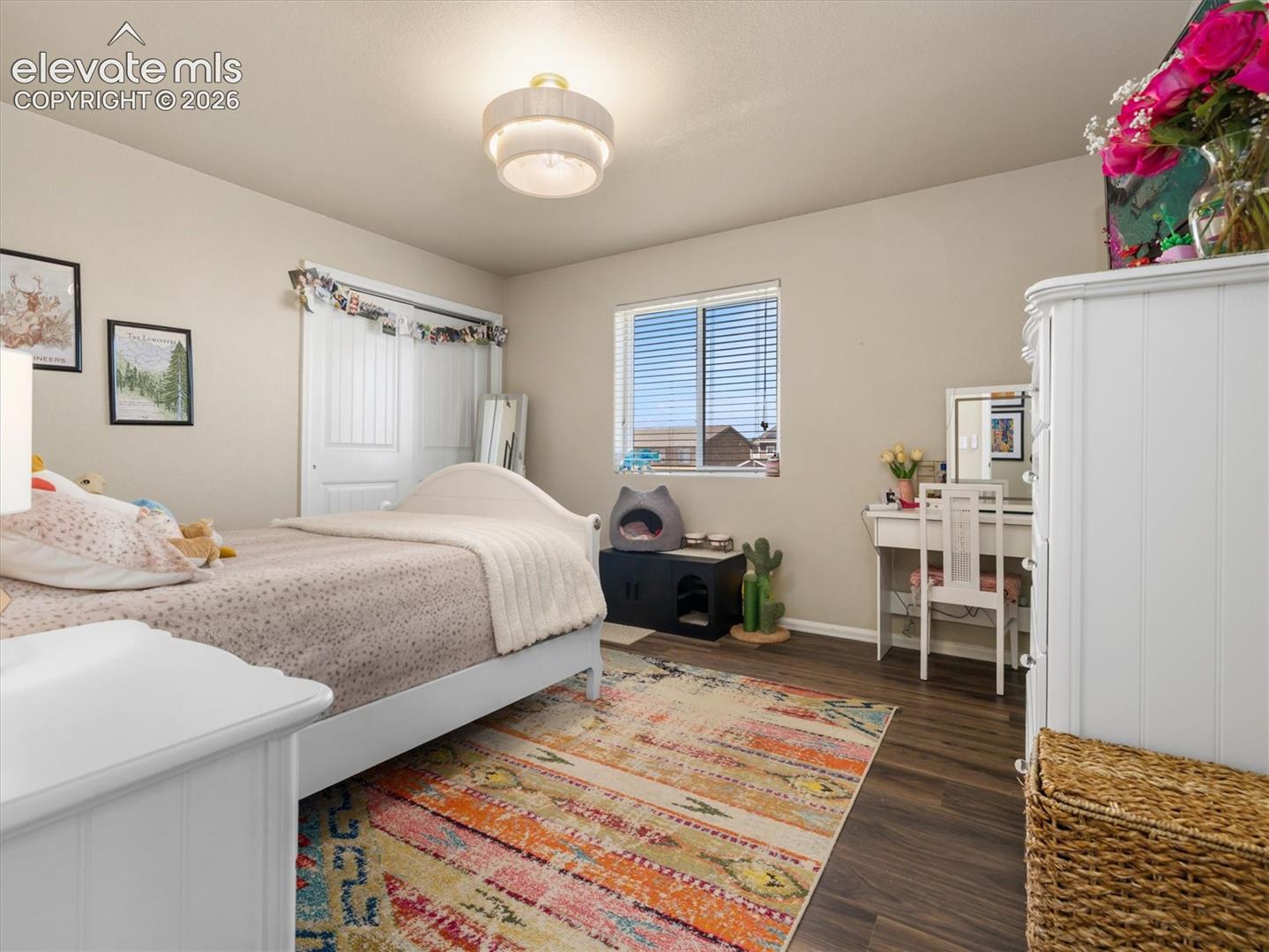 LVP flooring, a window with horizontal blinds, and a built-in closet with bi-fold doors