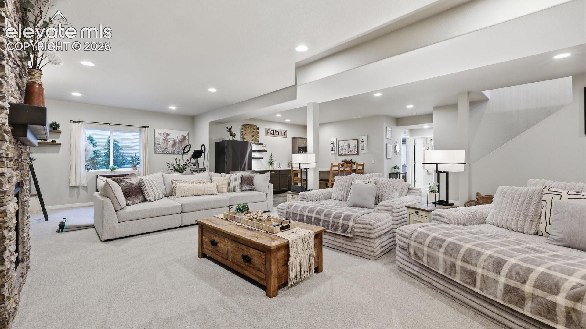 ROOM TO LIVE & ENTERTAIN — This impressive lower-level family room provides abundant space for movie nights, game days, entertaining, or simply unwinding in comfort.