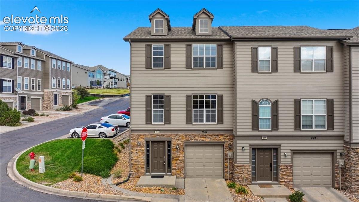 Three story end unit townhouse with tandem 2 car garage