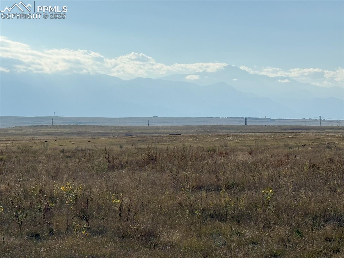 View of mountain backdrop featuring rural landscape