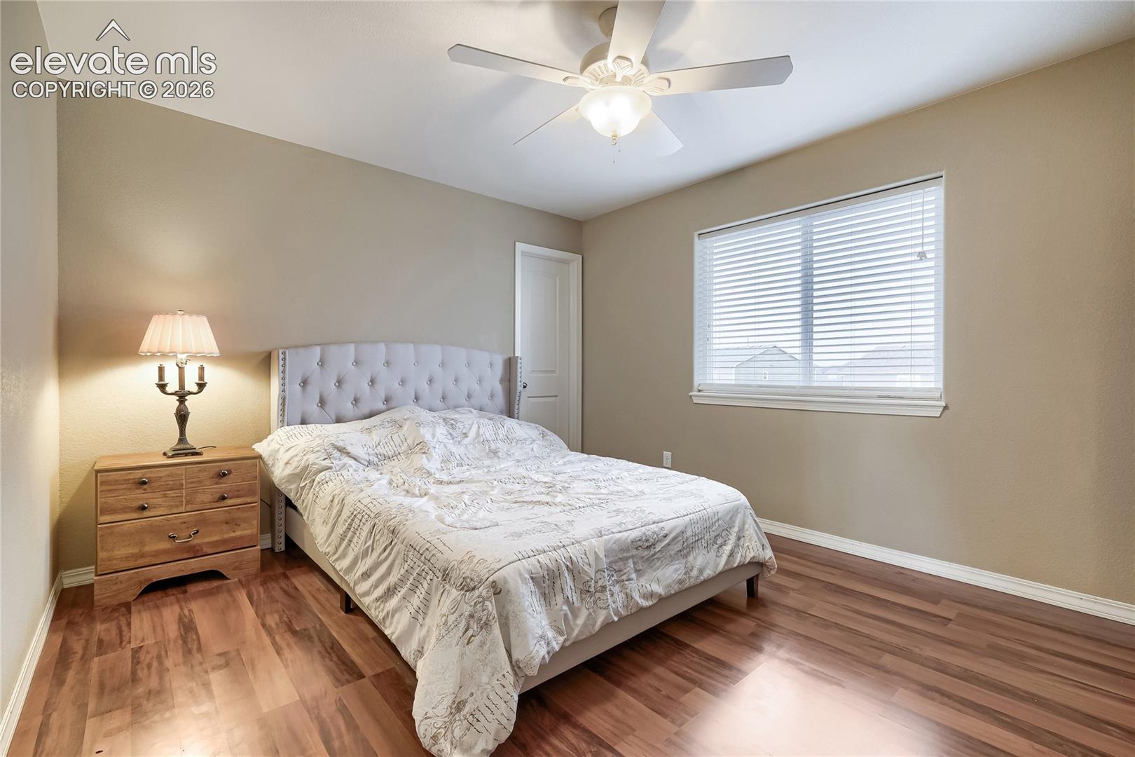 4th upper-level bedroom featuring wood-finish flooring, and walk-in closet