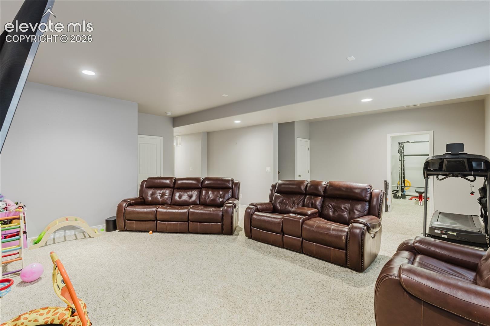 Carpeted lower level featuring recessed lighting, a neutral color palette, and multiple defined areas