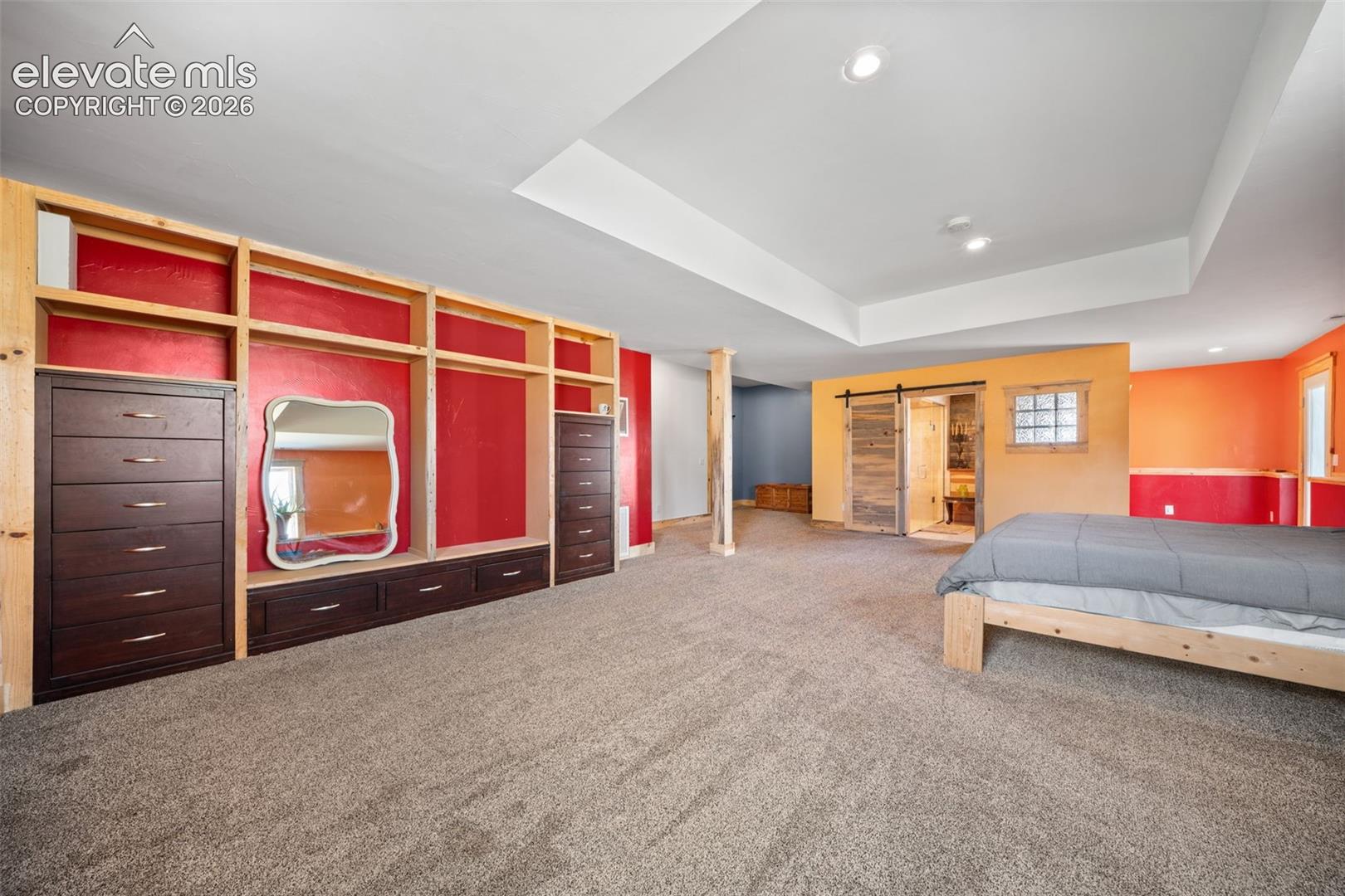 Expansive walkout primary bedroom with abundant space.