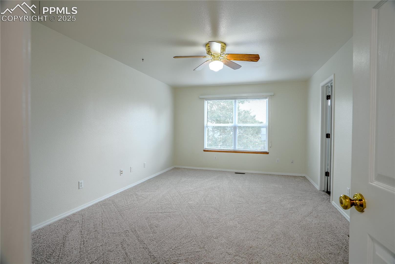 Primary bedroom with ceiling fan