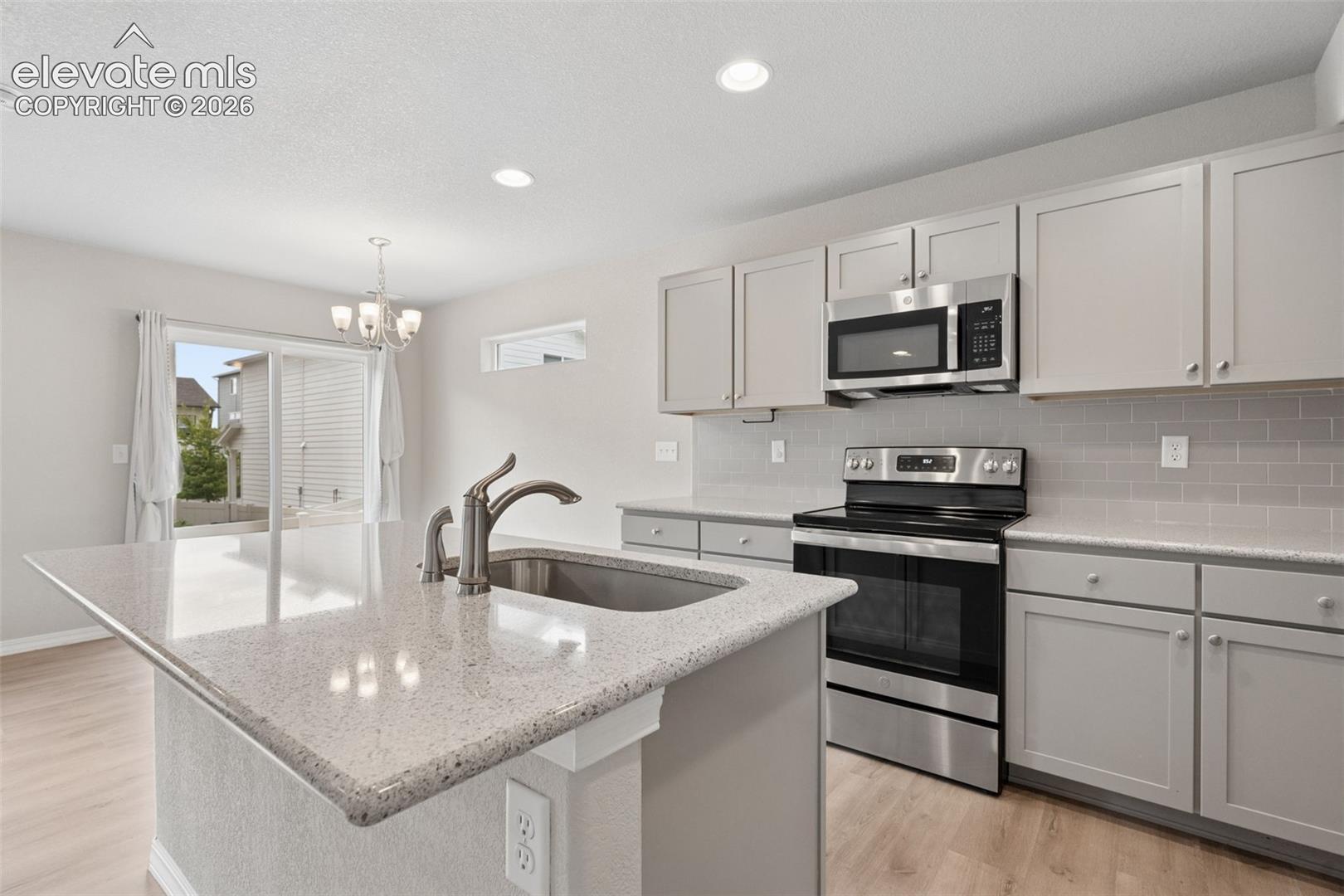 The Kitchen showcases gorgeous granite countertops, an island countertop, an abundance of cupboard space, a pantry, and comes fully equipped with a Refrigerator, Range, Dishwasher, and Microwave!