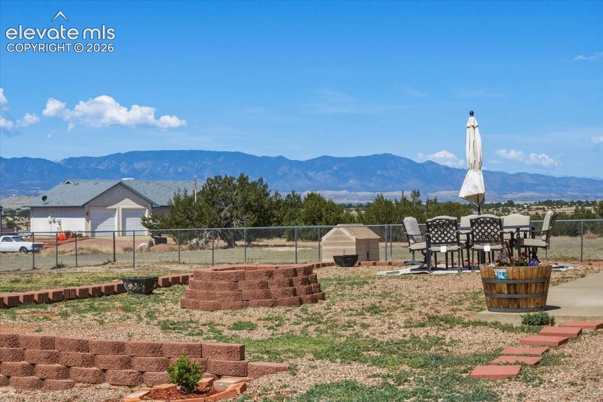 Backyard patio and firepit area offer an inviting space for evening gatherings and outdoor enjoyment.