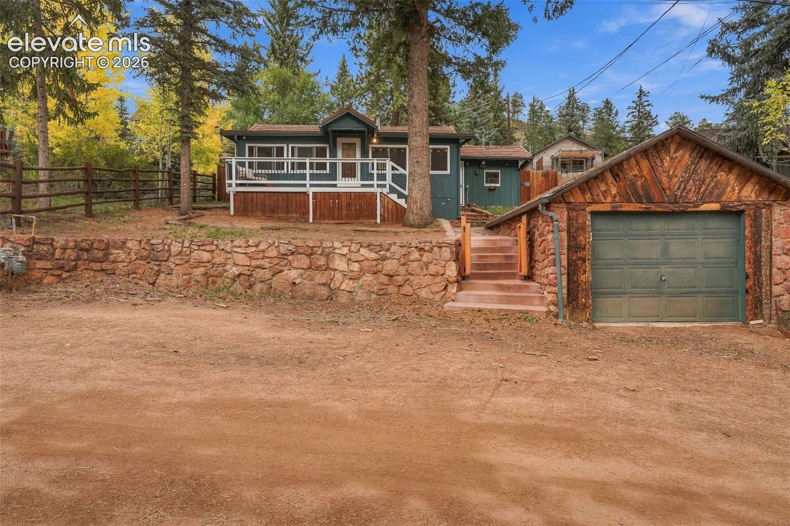 Front of home with detached 1 car garage.