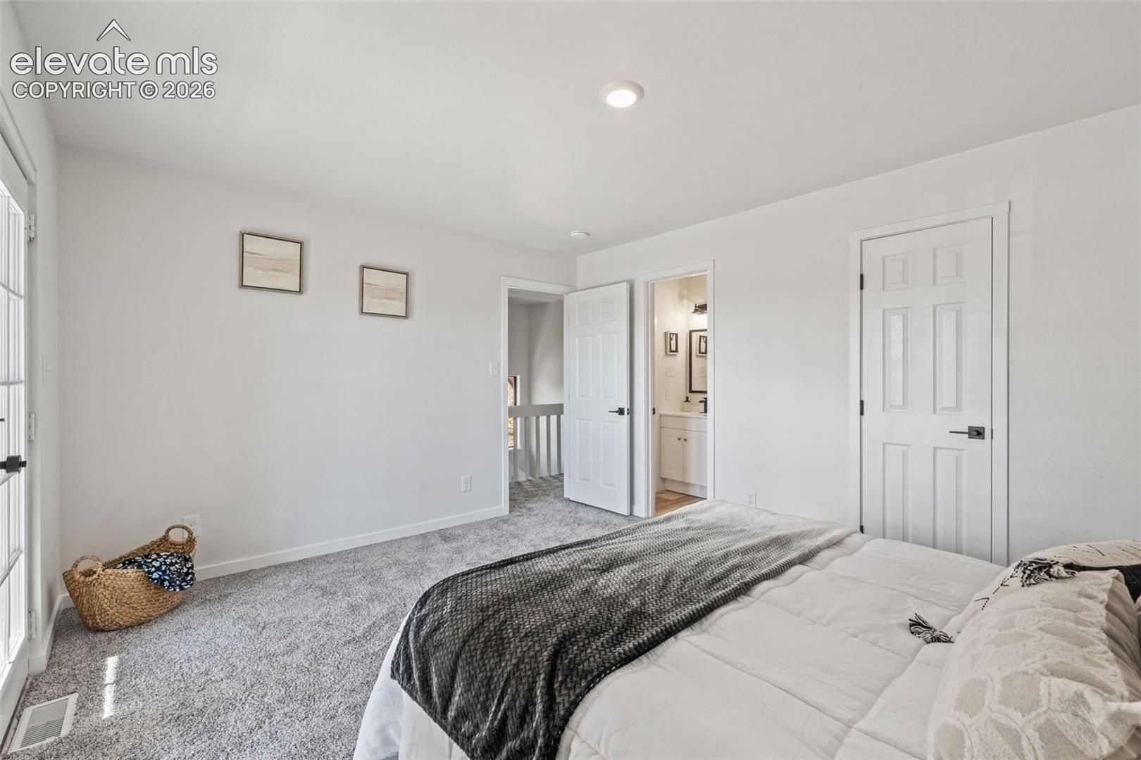 Neutral-toned carpeting, recessed ceiling lighting, and multi-panel interior doors