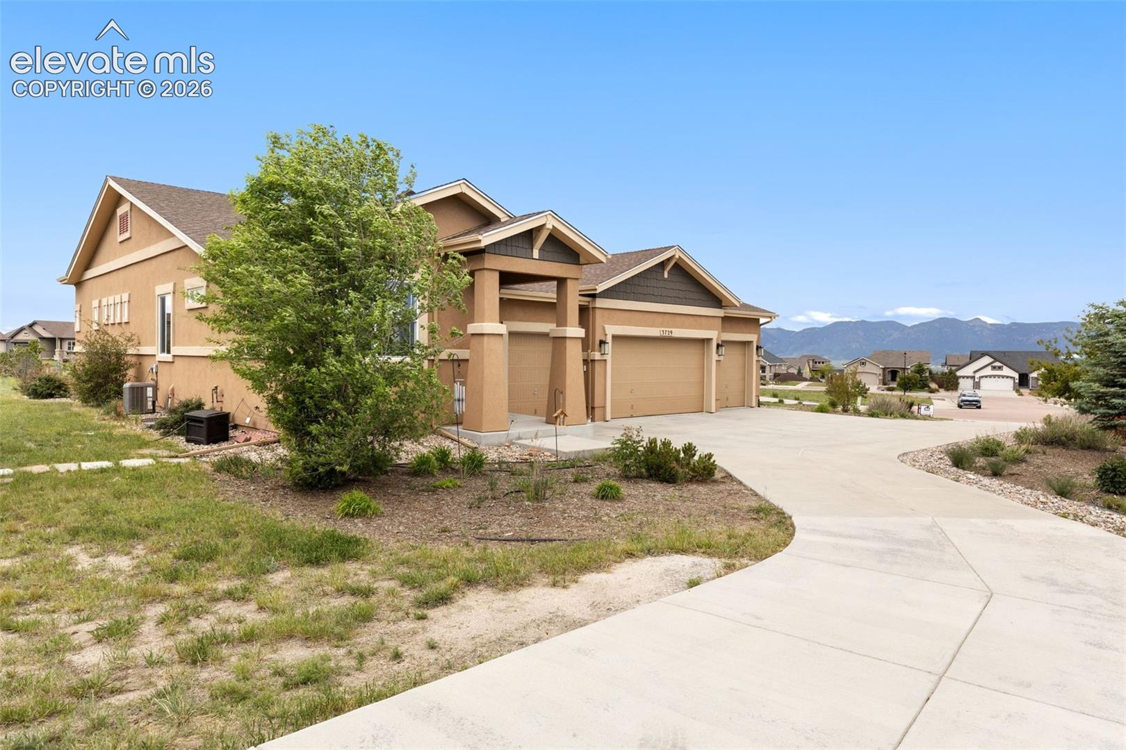 Front of house with 4 car garage and mountain views