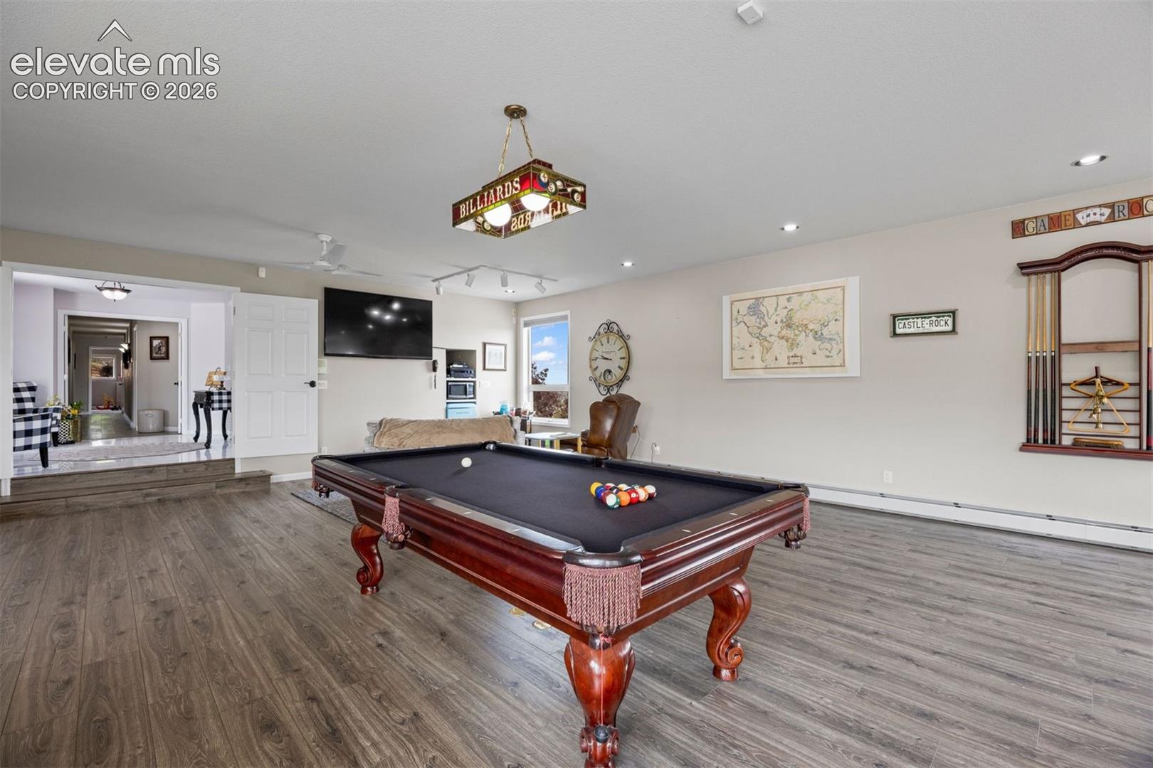 A large recreation room easily houses a billiards table, sitting areas, and craft or office space. 