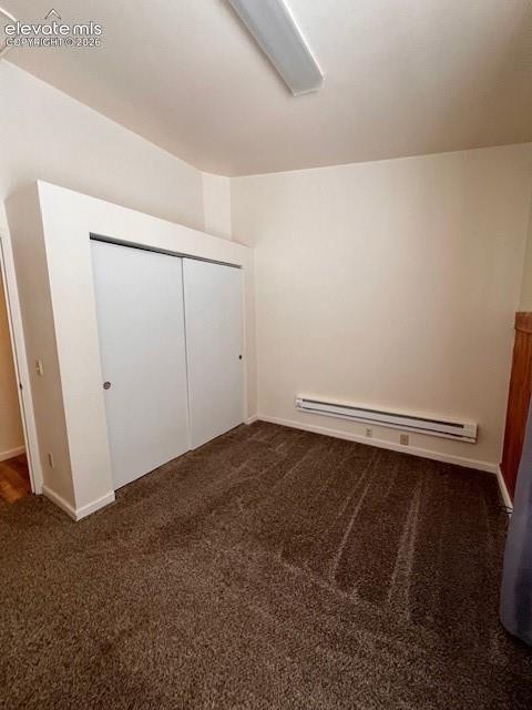 Interior space featuring neutral wall tones, wall-to-wall carpeting, and a double-door closet