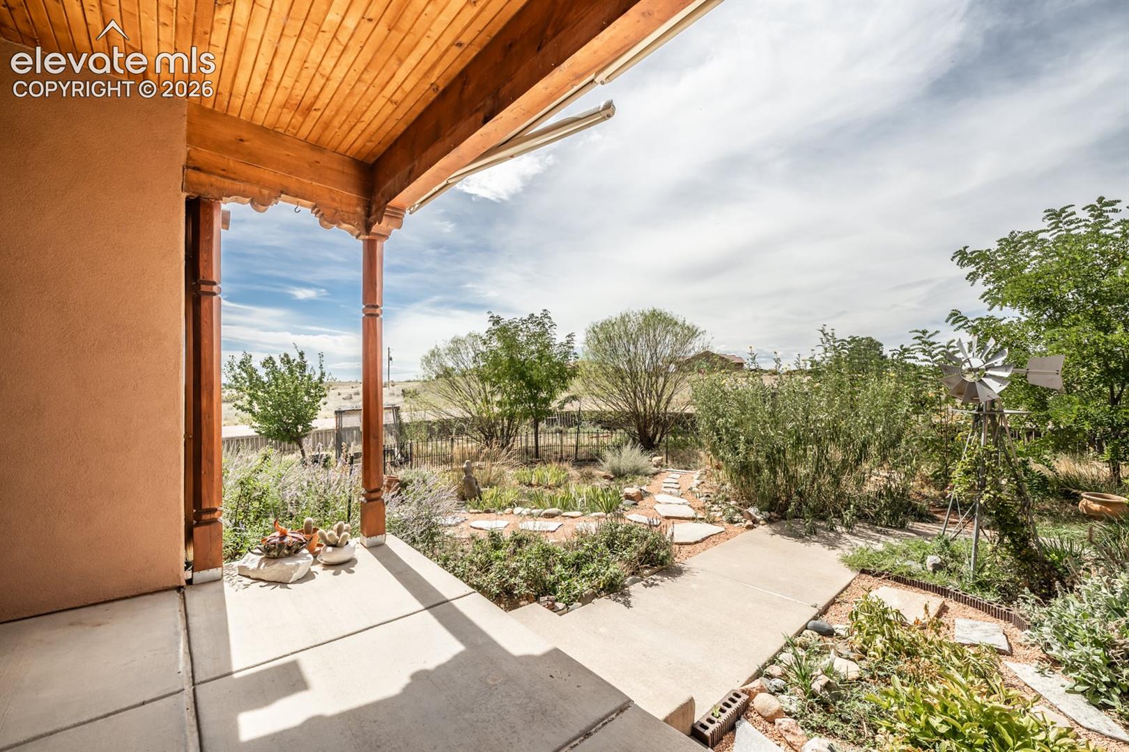 Front door faces west overlooking this gem of a yard.  Perfect to sit out on covered entry capturing the dramatic, fiery sunsets that define the Colorado sky.  Or catch a storm rolling over the mountains.