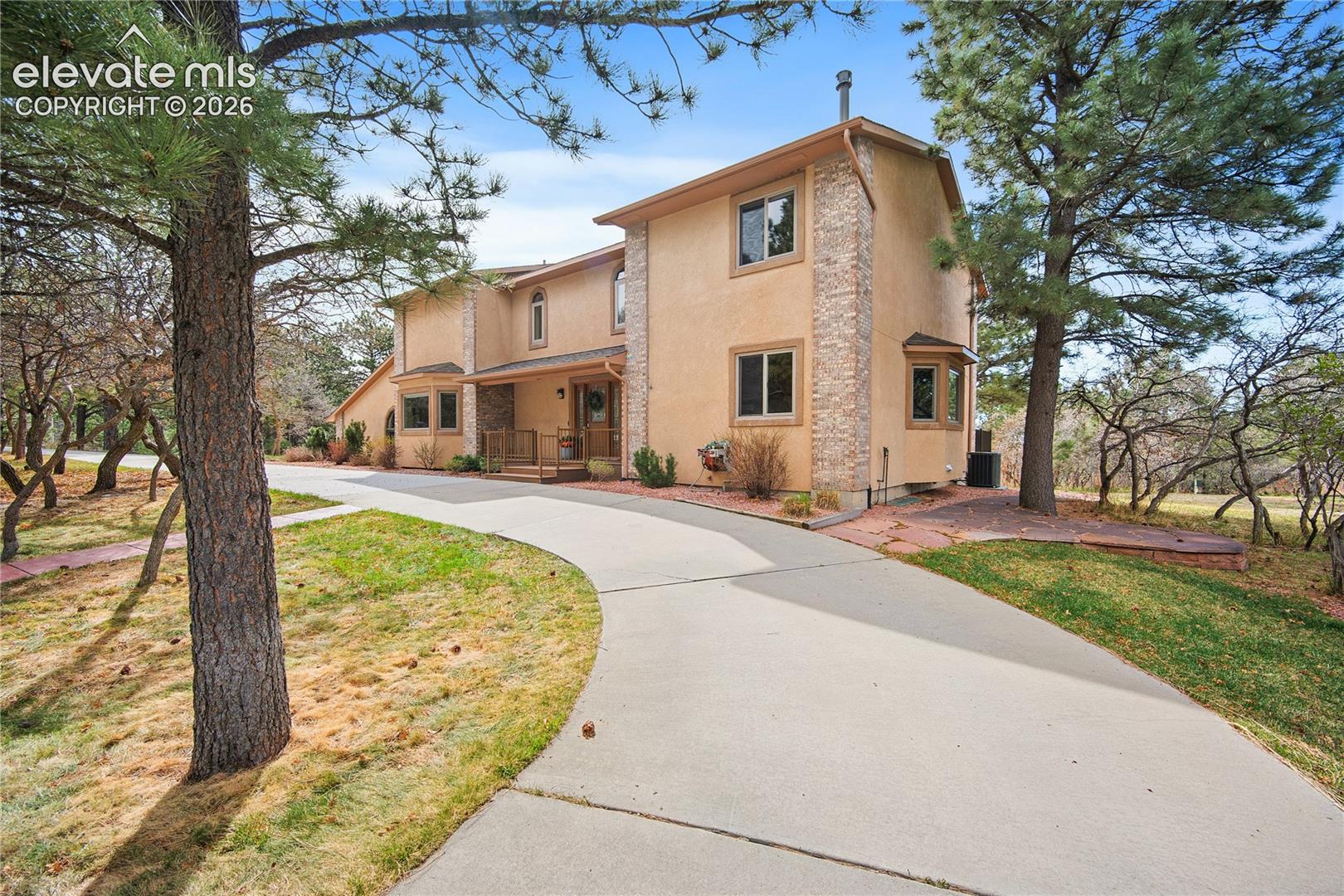 Tucked away in the Woodmoor Oaks neighborhood, this stunning home boasts a beautiful exterior, covered front porch and surrounded by mature trees and oak brush. 